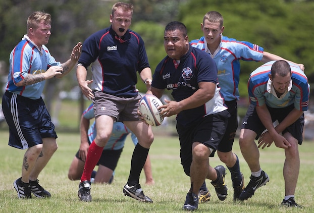 HONOLULU - Ronny Movete (center) runs the ball to score for the Marines team during the Marine and Navy rugby scrimmage at Kapiolani Park, May 25. Although no official score was kept, the Marines completed more successful plays than the Navy team. (U.S. Marine Corps photo taken by Lance Cpl. Matthew Bragg)