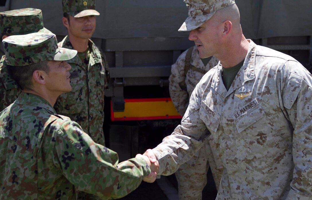 Lieutenant Col. Troy Roesti, executive officer of the 31st Marine Expeditionary Unit, greets soldiers of 12th Infantry Regiment, 8th Division, Western Army, Japanese Ground Self Defense Forces, during their arrival here, May 29. As part of the Japanese Observer Exchange Program, the soldiers will live alongside Marines and Sailors of the 31st MEU while observing approximately three weeks of amphibious operations. By sharing small unit concepts and tactics for amphibious operations, the two forces aim to increase interoperability and strengthen bilateral response to future challenges.