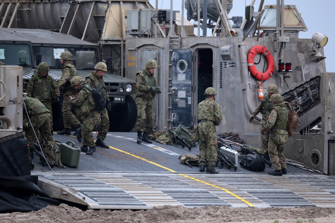 Japanese Ground Self Defense Force (JGSDF) soldiers unload weapons and vehicles from a landing craft air cushion (LCAC) as part of Exercise Dawn Blitz here, May 31, 2013. Dawn Blitz 2013 is a multinational amphibious exercise off the Southern California coast that refocuses Navy and Marine Corps and coalition forces in their ability to conduct complex amphibious operations essential for global crisis response across the range of military operations. (Photo by U.S. Marine Corps Cpl. Jonathan R. Waldman, 11TH MEU, Combat Camera/Released)
