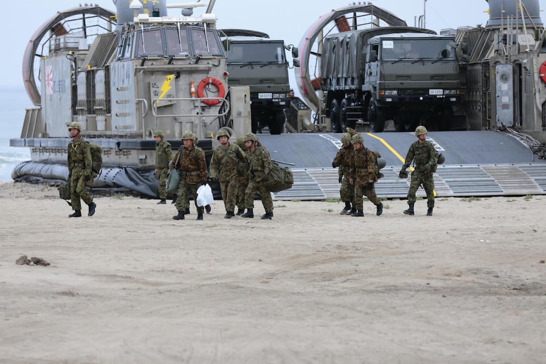 Japanese Ground Self Defense Force (JSDF) soldiers unload weapons and vehicles from a landing craft air cushion (LCAC) as part of Exercise Dawn Blitz, Camp Pendleton, CA, May 31, 2013. Dawn Blitz 2013 is a multinational amphibious exercise off the Southern California coast that refocuses Navy and Marine Corps and coalition forces in their ability to conduct complex amphibious operations essential for global crisis response across the range of military operations. (Photo by U.S. Marine Corps Gunnery Sgt. Chance W. Haworth, 11TH MEU, Combat Camera/Released)