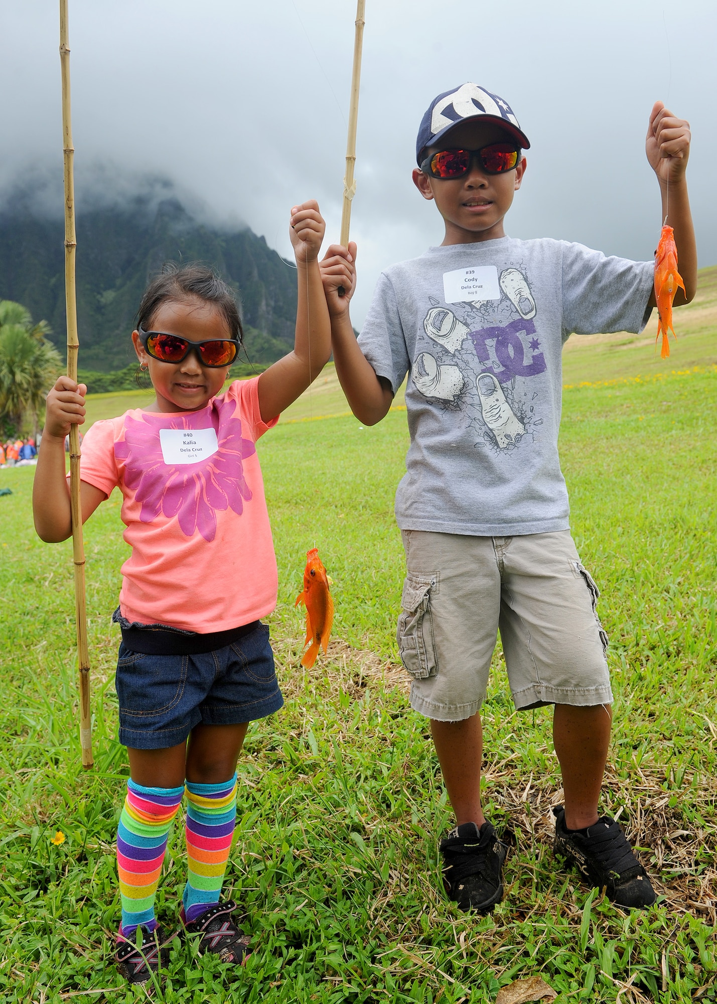 Kalia Dela Cruz, 5 and her older brother Cody Dela Cruz, 9, pose with fish they caught during the Friends of Hickam Keiki Fishing Tournament at the Ho`omaluhia Botanical Gardens in Kaneohe, Hawaii, May 29, 2013. This is the 14th straight year the Friends of Hickam has hosted the event for more than 100 children. (U.S.  Air Force photo/Tech. Sgt.  Jerome S. Tayborn)