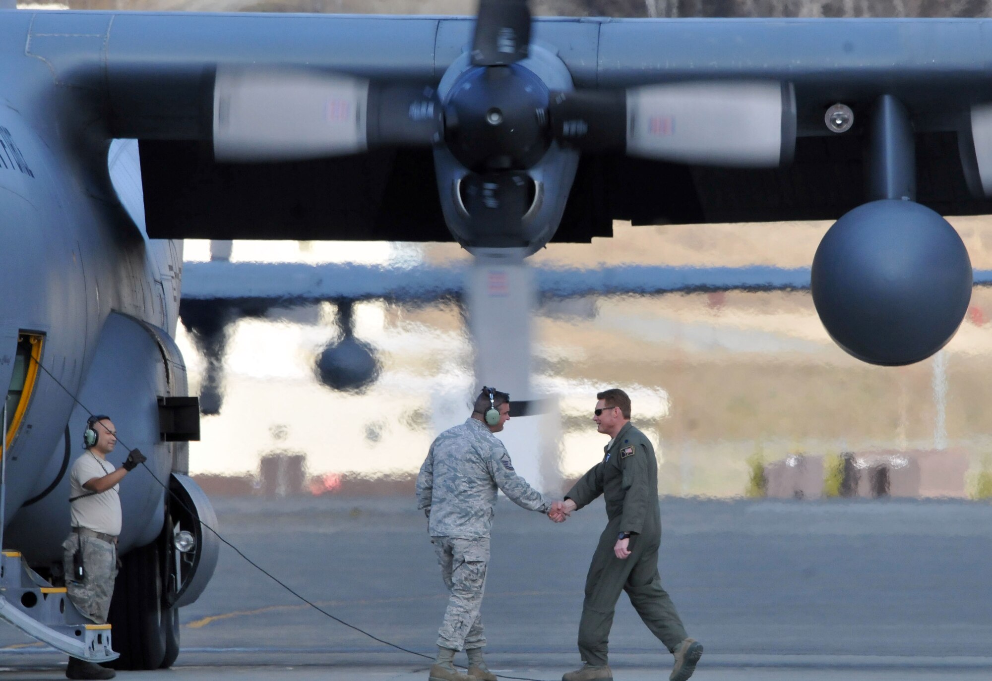 JOINT BASE ELMENDORF-RICHARDSON, Alaska -- Lt. Col. Blake Gettys, commander of the 176 Operations Group, bids farewell to Master Sgt. Derek Netzly, a member of the Ohio Air National Guard's 179th Airlift Squadron and the new crew chief of C-130 cargo plane "Five Four" here May 23, 2013. The "Five Four" is one of three C-130s that were transferred from the Alaska Air National Guard's 176 Wing to the Ohio Air National Guard's 179th Airlift Wing. National Guard photo by Staff Sgt. N. Alicia Goldberger. 