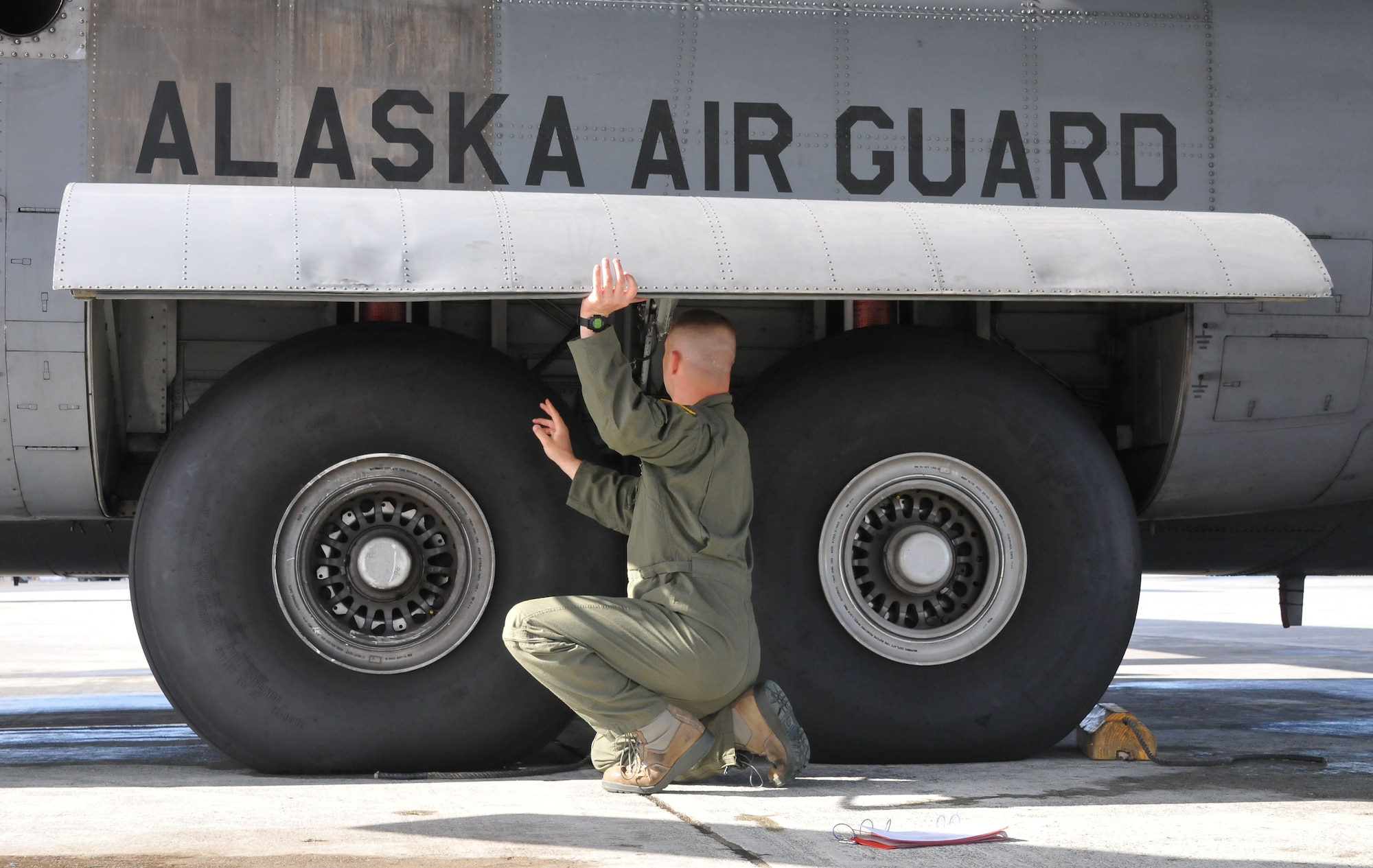 JOINT BASE ELMENDORF-RICHARDSON, Alaska -- Tech. Sgt. Brian Cannon, a flight engineer with the Arkansas Air National Guard's 154th Training Squadron, inspects a C-130 cargo aircraft on the flightline here May 23, 2013. The C-130 was one of three being transferred from the Alaska Air National Guard's 176 Wing to the Ohio Air National Guard's 179th Airlift Wing. National Guard photo by Staff Sgt. N. Alicia Goldberger. 