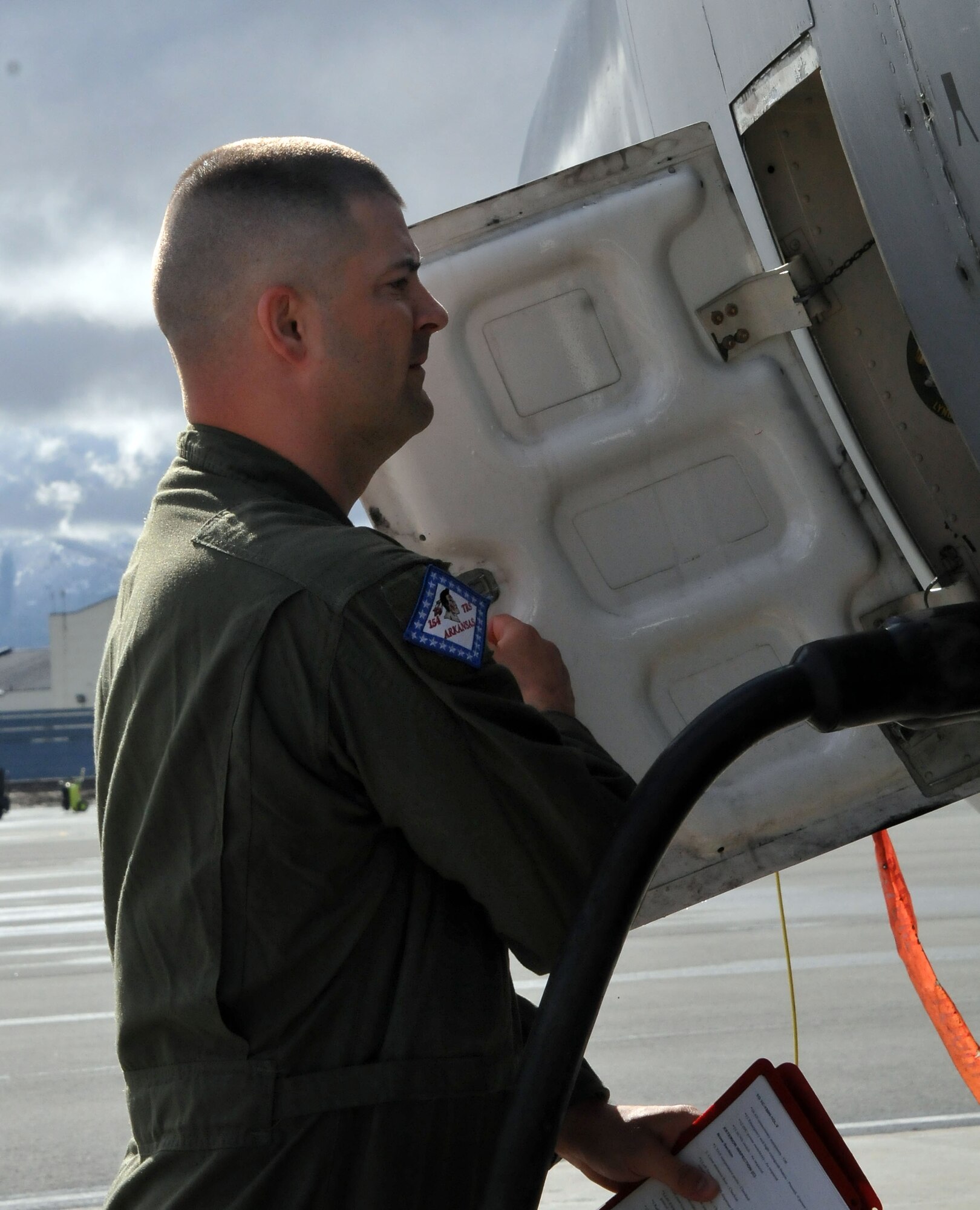 JOINT BASE ELMENDORF-RICHARDSON, Alaska -- Tech. Sgt. Brian Cannon, a flight engineer with the Arkansas Air National Guard's 154th Training Squadron, inspects a C-130 cargo aircraft on the flightline here May 23, 2013. The C-130 was one of three being transferred from the Alaska Air National Guard's 176 Wing to the Ohio Air National Guard's 179th Airlift Wing. National Guard photo by Staff Sgt. N. Alicia Goldberger. 