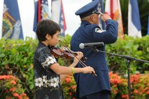 Ethan Hillman plays the national anthem on violin during the 647th Air Base Group change of command ceremony on 31 May 2013 at the Missing Man Formation on Hickam Field, Joint Base Pearl Harbor-Hickam, Hawaii. Ethan is the son of Lt. Col. David Hillman, Commander, 747th Communications Squadron. (Photo by David D. Underwood, Jr.)
