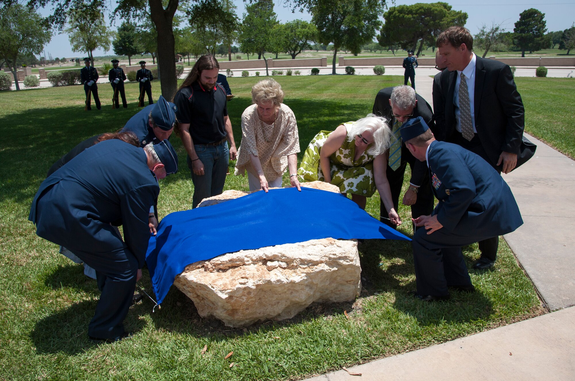 Laughlin leadership and family members of the deceased lift the veil covering a memorial dedicated to 22 deceased instructor pilots here at Laughlin Air Force Base, Texas, May 31, 2013. A memorial ceremony took place to celebrate the lives of those pilots who gave their lives in Southeast Asia during the Vietnam War. (U.S. Air Force photo/Airman 1st Class John D. Partlow)