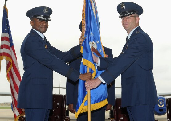 Lt. Gen. Darren McDew, 18th Air Force commander, passes the 22nd Air Refueling Wing guidon to Col. Joel Jackson, during a change of command ceremony May 31, 2013, McConnell Air Force Base, Kan. Jackson has served in a variety of squadron, group and wing level positions, including tours on the Air Staff, the Office of the Secretary of Defense and U.S. Transportation Command. (U.S. Air Force photo/Senior Airman Katrina M. Brisbin)