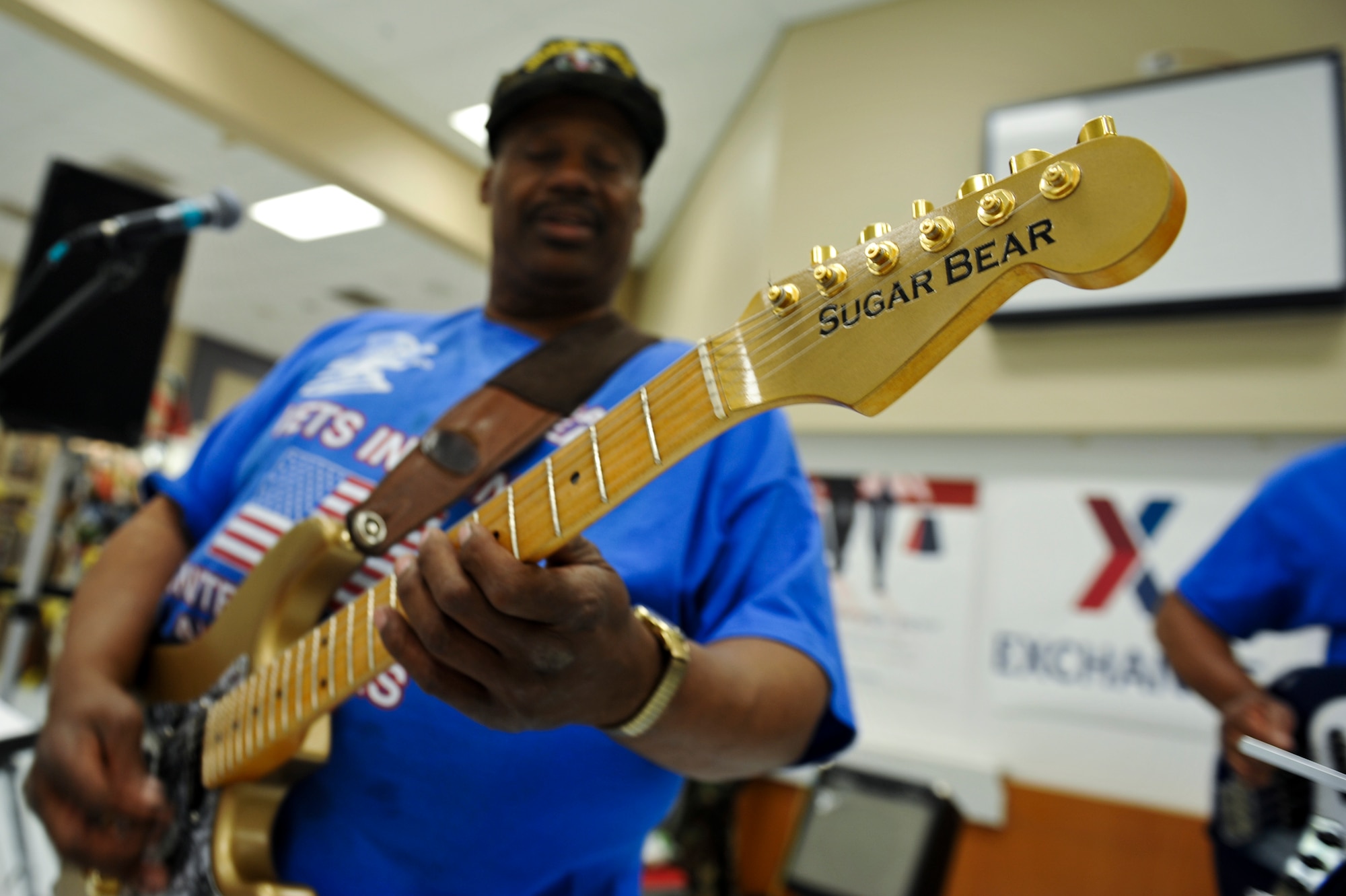 Gary Satchell, Vets in Tune guitarist and vocalist, plays a riff during a performance May 17, 2013, at The Exchange on Buckley Air Force Base, Colo. Satchell, a disabled U.S. Air Force veteran from the Denver area, is one of four members that make up the Vets in Tune band. (U.S. Air Force photo by Airman 1st Class Riley Johnson/Released)