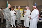 Col. Mark Camerer, 37th Training Wing commander, (center) and Chief Master Sgt. Craig Recker, 37th TRW command chief master sergeant, (left) visit with members of the Saudi military. Navy Warrant Officer 2 Abdulaziz Al Qahtani and Saudi air force Warrant Officer Abdulrahman Al Shehri discuss their culture and customs with Camerer while Saudi navy Warrant Officer 2 Ali Al Zahrani talks to Recker. Al Qahtani and Al Shehri are wearing their traditional dress.  (Photo by Alan Boedeker)