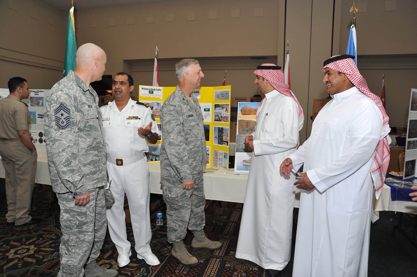 Col. Mark Camerer, 37th Training Wing commander, (center) and Chief Master Sgt. Craig Recker, 37th TRW command chief master sergeant, (left) visit with members of the Saudi military. Navy Warrant Officer 2 Abdulaziz Al Qahtani and Saudi air force Warrant Officer Abdulrahman Al Shehri discuss their culture and customs with Camerer while Saudi navy Warrant Officer 2 Ali Al Zahrani talks to Recker. Al Qahtani and Al Shehri are wearing their traditional dress.  (Photo by Alan Boedeker)