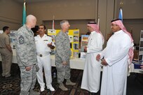 Col. Mark Camerer, 37th Training Wing commander, (center) and Chief Master Sgt. Craig Recker, 37th TRW command chief master sergeant, (left) visit with members of the Saudi military. Navy Warrant Officer 2 Abdulaziz Al Qahtani and Saudi air force Warrant Officer Abdulrahman Al Shehri discuss their culture and customs with Camerer while Saudi navy Warrant Officer 2 Ali Al Zahrani talks to Recker. Al Qahtani and Al Shehri are wearing their traditional dress.  (Photo by Alan Boedeker)