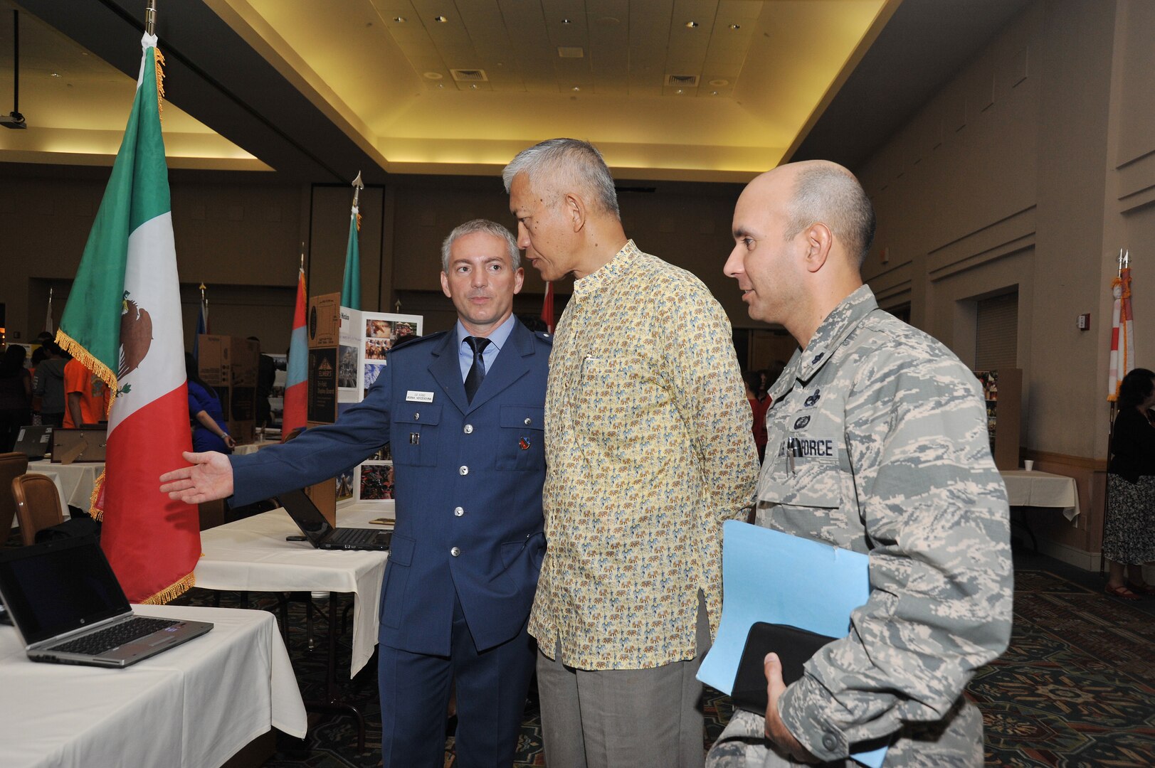 Capt. Zlatko Kosic talks about Bosnia Herzegovina to former United Nations Ambassador Sichan Siv and Lt. Col. David Rodriguez, 433rd Operations Squadron commander.  (Photo by Alan Boedeker)
