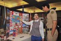 LacSusanna Sasajyan, a Basic American Language Instructor Course student proudly describes her home country of Armenia to Saudi air force Second Lieutenant Abdulaziz Almalki.  (Photo by Alan Boedeker)
