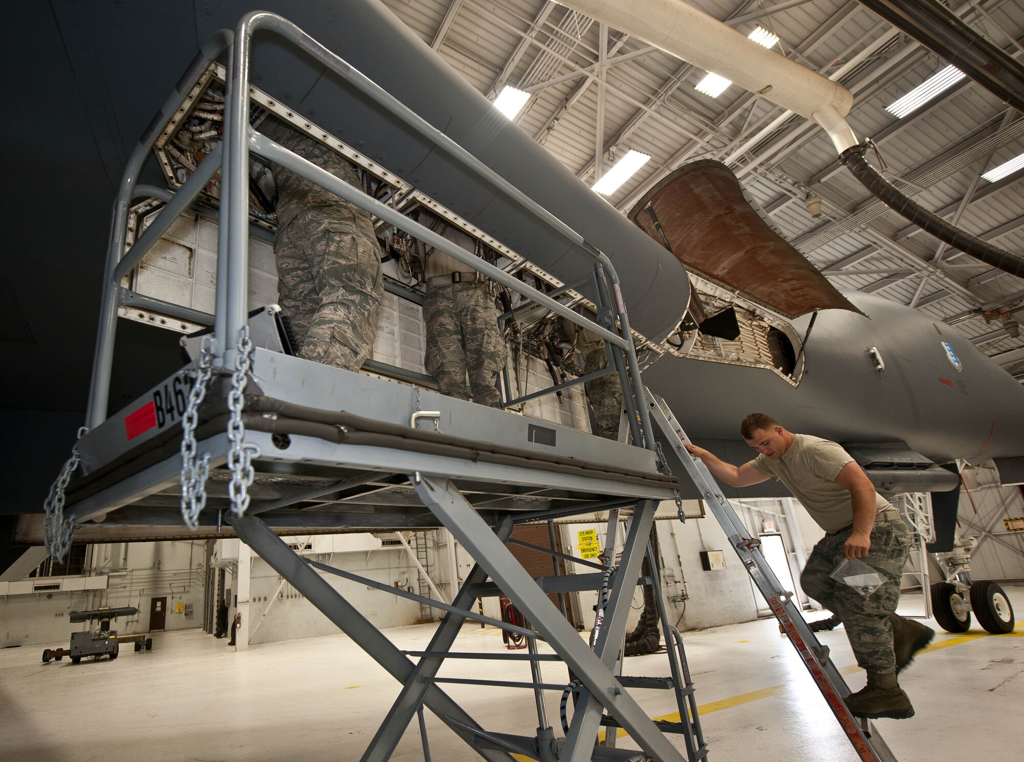 Defensive avionic systems specialists assigned to the 28th Aircraft Maintenance Squadron re-install a wire harness on a B-1 bomber following corrosion damage repairs found during an inspection at Ellsworth Air Force Base, S.D., May 29, 2013. Defensive avionic systems specialists are one of the six teams in the 28th AMXS’s specialist section who are responsible for making sure each B-1 at Ellsworth functions properly. (U.S. Air Force photo by Airman 1st Class Zachary Hada/Released)