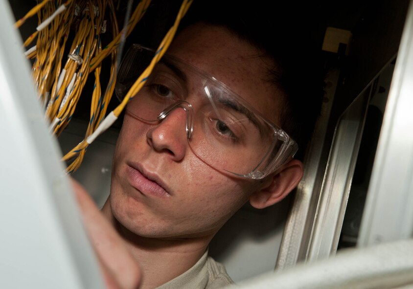 Airman 1st Class Aaron Riley, 28th Aircraft Maintenance Squadron defensive avionic systems technician, re-installs a wire harness on a B-1 bomber after repairing corrosion damage found during an inspection at Ellsworth Air Force Base, S.D., May 29, 2013. Defensive avionic systems are mission essential countermeasures systems used by aviators to detect and avoid, or counteract, threats they may encounter during combat missions. (U.S. Air Force photo by Airman 1st Class Zachary Hada/Released)
