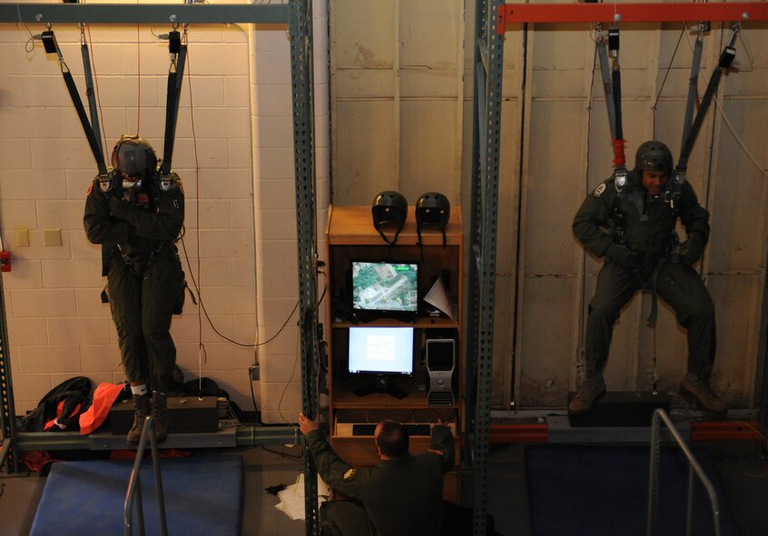 Aircrew personnel steer a parachute during a simulation on Barksdale Air Force Base, La., May 31, 2013. The parachute simulator can be programmed to put aircrew members in multiple scenarios, some of which include landing in large bodies of water, an urban environment or having to maneuver through strong winds. (U.S. Air Force photo/Airman 1st Class Benjamin Gonsier)