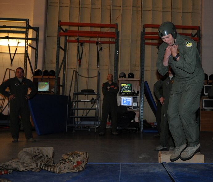 Maj. David Pabst, 11th Bomb Squadron electronic warfare officer instructor, performs a parachute landing fall on Barksdale Air Force Base, La., May 31, 2013. During the landing process, aircrew must perform the proper landing procedures in order to minimize injuries. (U.S. Air Force photo/Airman 1st Class Benjamin Gonsier)