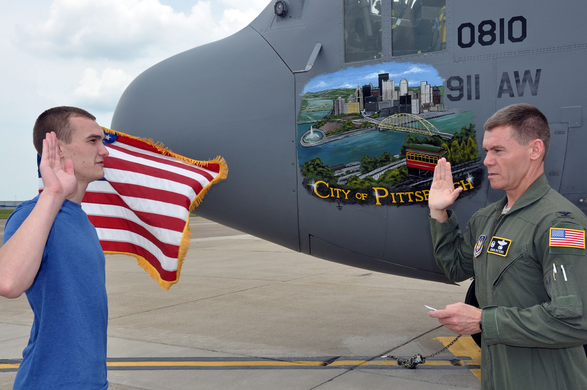 Brendin Peters, receives the oath of enlistment from his father, Col. Craig C. Peters, 911th Airlift Wing commander during an enlistment ceremony held in front of one of the unit’s C-130s, May 30, 2013 at the Pittsburgh International Airport Air Reserve Station.  Airman 1st Class Peters is projected to leave for Basic Military Training School at Lackland Air Force Base, Texas, in early July. After eight and a half weeks of BMTS, he will remain at Lackland to attend the fundamental school for loadmasters.  From there, he will be sent to technical school at Altus AFB, Okla., for loadmaster training on the C-5 Galaxy.  After completion of training, Airman 1st Class Peters will be assigned to Westover Air Reserve Base, Mass. (U.S. Air Force photo by Capt. Shawn M. Walleck)