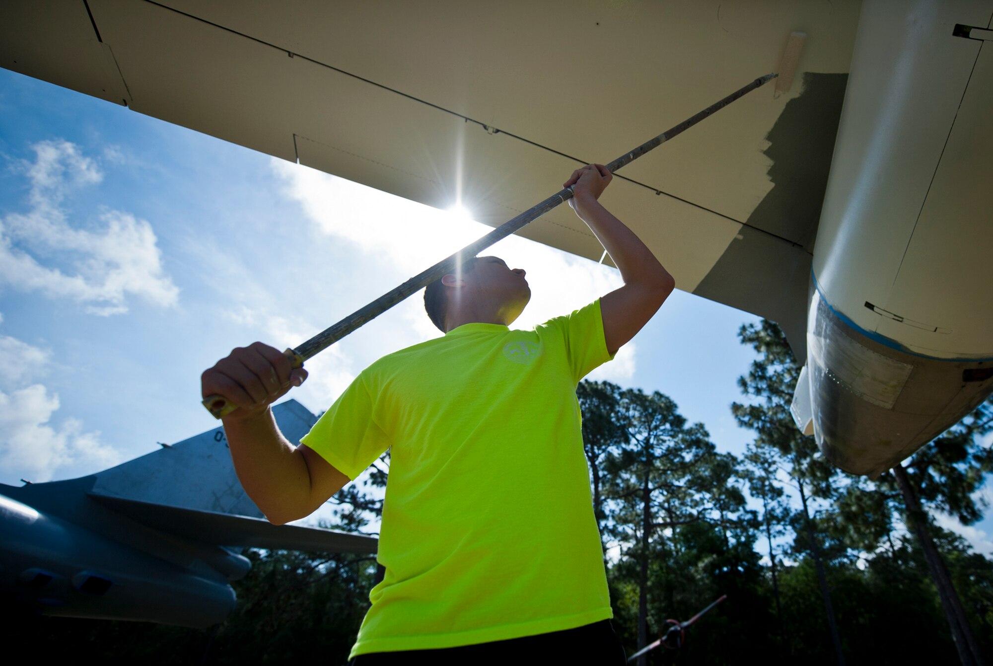 Airman 1st Class Anthony Colon Matos, of the 96th Logistics Readiness Squadron, paints the underside of a B-47 aircraft display at the Air Force Armament Museum, May 25. Colon Matos and other members of LRS’s petroleum, oil and lubricants flight work to restore the B-47 as part of Eglin’s Adopt-a-Plane program.  It has been almost 13 years since the B-47 was renovated.  The newly restored aircraft is scheduled to be completed in July. (U.S. Air Force photo/Samuel King Jr.)