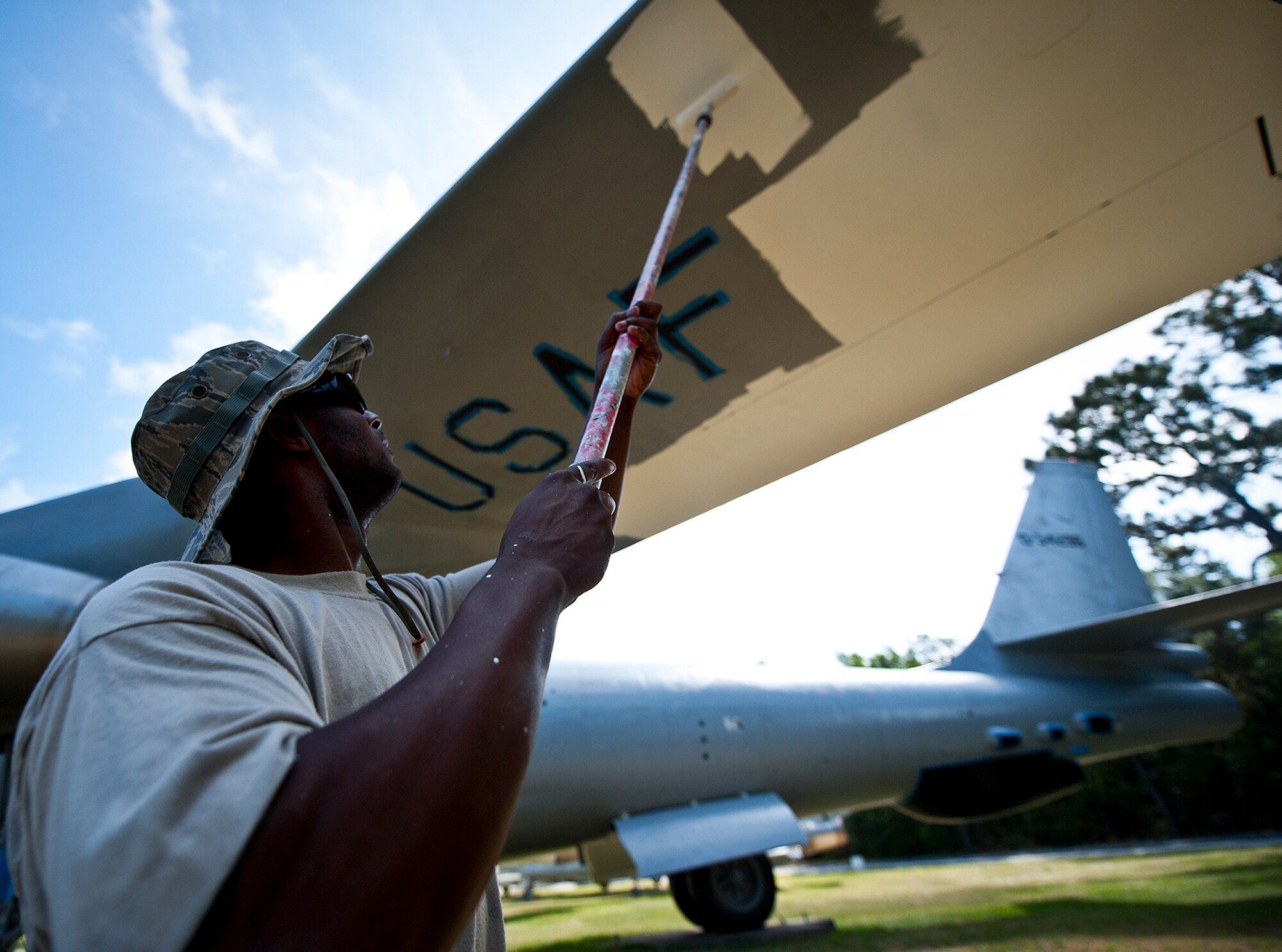 Tech. Sgt. Lee Gore, of the 96th Logistics Readiness Squadron, paints the underside of a B-47 aircraft display at the Air Force Armament Museum, May 25. Gore and other members of LRS’s petroleum, oil and lubricants flight work to restore the B-47 as part of Eglin’s Adopt-a-Plane program.  It has been almost 13 years since the B-47 was renovated.  The newly restored aircraft is scheduled to be completed in July. (U.S. Air Force photo/Samuel King Jr.)