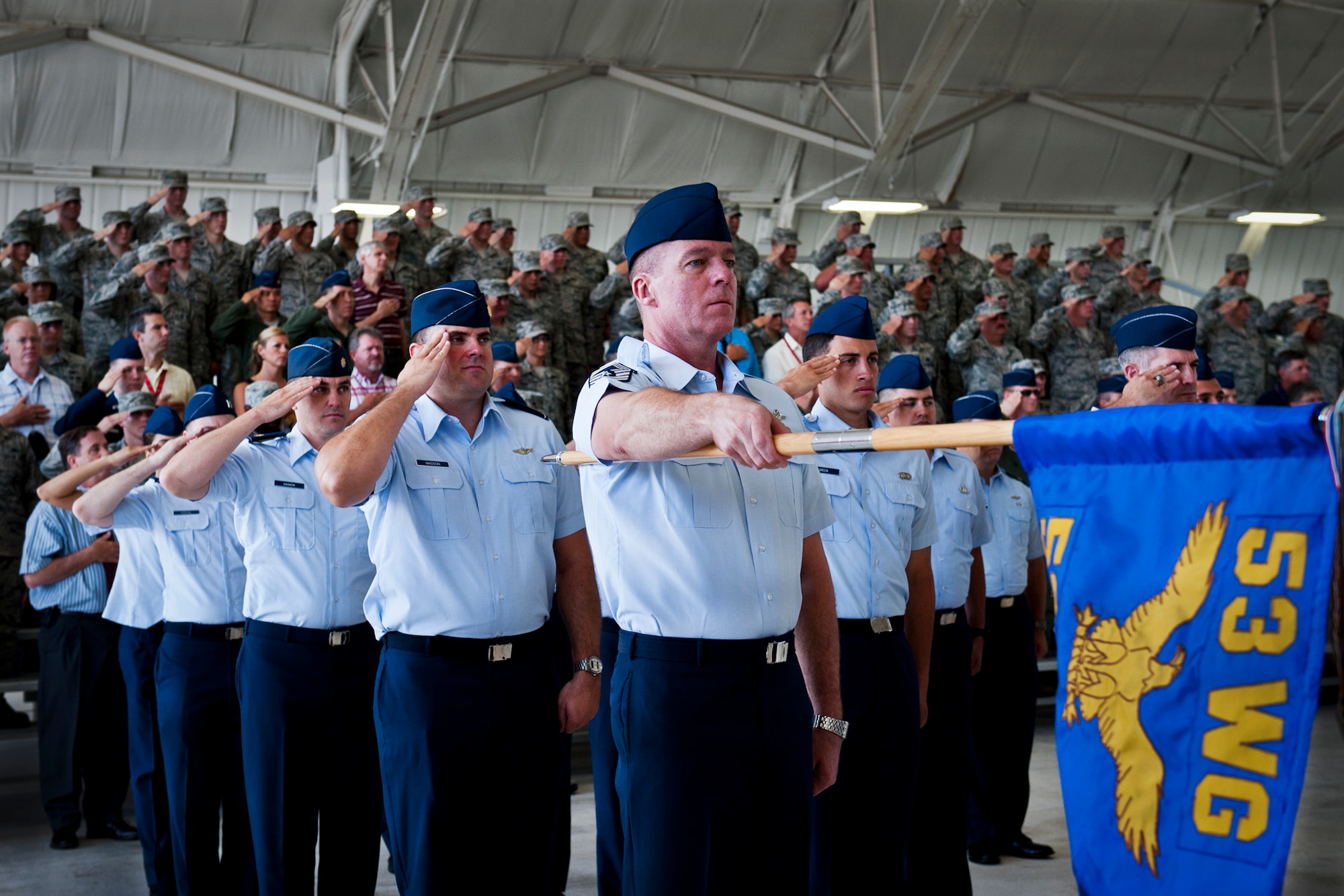 Chief Master Sgt. Jeffery Duncan and a flight of 53rd Test and Evaluation Group Airmen salute during the National Anthem at the 53rd Wing change of command ceremony May 30 at Eglin Air Force Base, Fla.  Col. Alexus Grynkewich took command of the wing from Col. David Hicks, who leaves to become the deputy director of operations for North American Aerospace Defense Command at Peterson, AFB, Colo.  (U.S. Air Force photo/Samuel King Jr.)