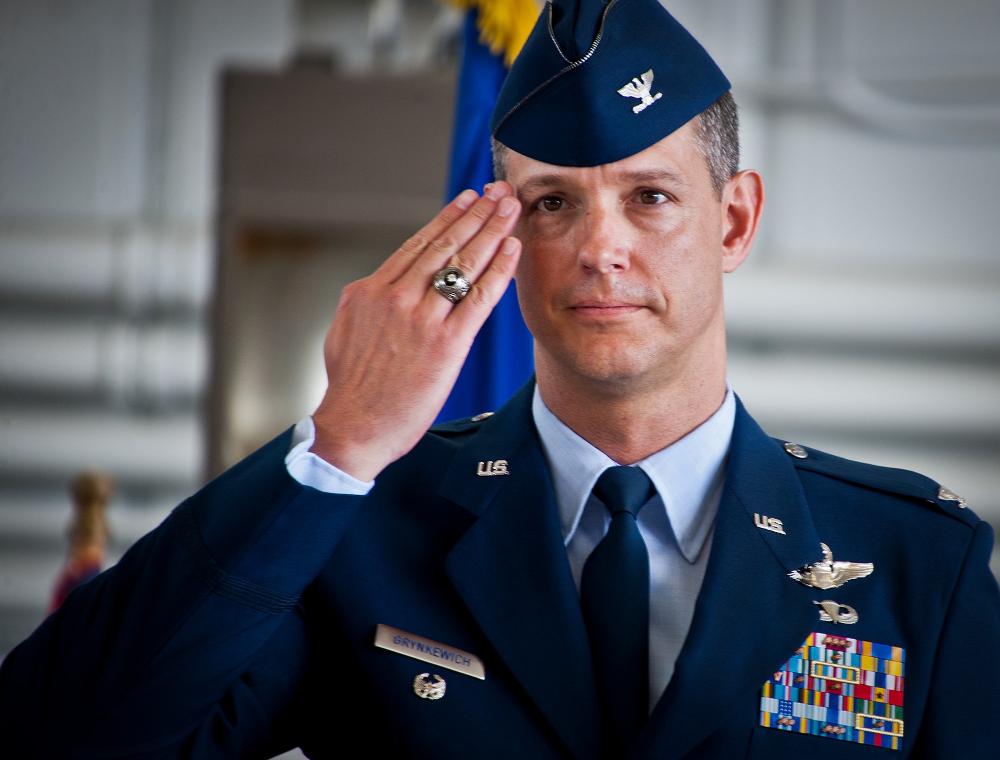 Col. Alexus Grynkewich salutes the 53rd Wing for the first time as its commander during a change of command ceremony May 30 at Eglin Air Force Base, Fla.  Grynkewich took command of the wing from Col. David Hicks, who leaves to become the deputy director of operations for North American Aerospace Defense Command at Peterson, AFB, Colo.  (U.S. Air Force photo/Samuel King Jr.)