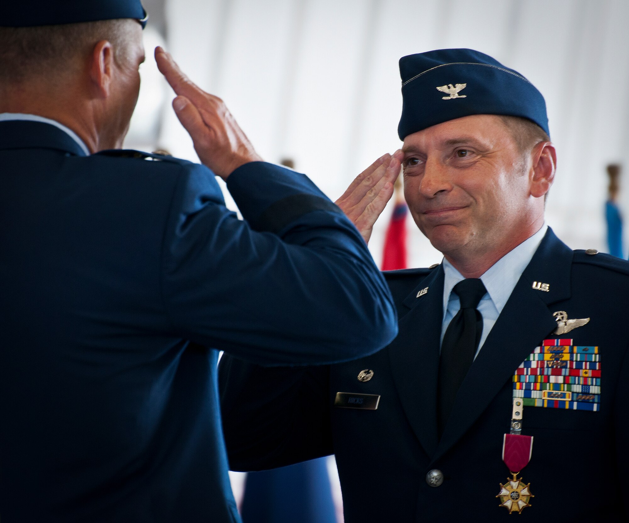 Col. David Hicks salutes Maj. Gen. Jeffrey Lofgren, the U.S. Air Force Warfare Center commander, after turning over command during the 53rd Wing’s change of command ceremony May 30 at Eglin Air Force Base, Fla.  Col. Alexus Grynkewich took command of the wing from Hicks, who leaves to become the deputy director of operations for North American Aerospace Defense Command at Peterson, AFB, Colo.  (U.S. Air Force photo/Samuel King Jr.)
