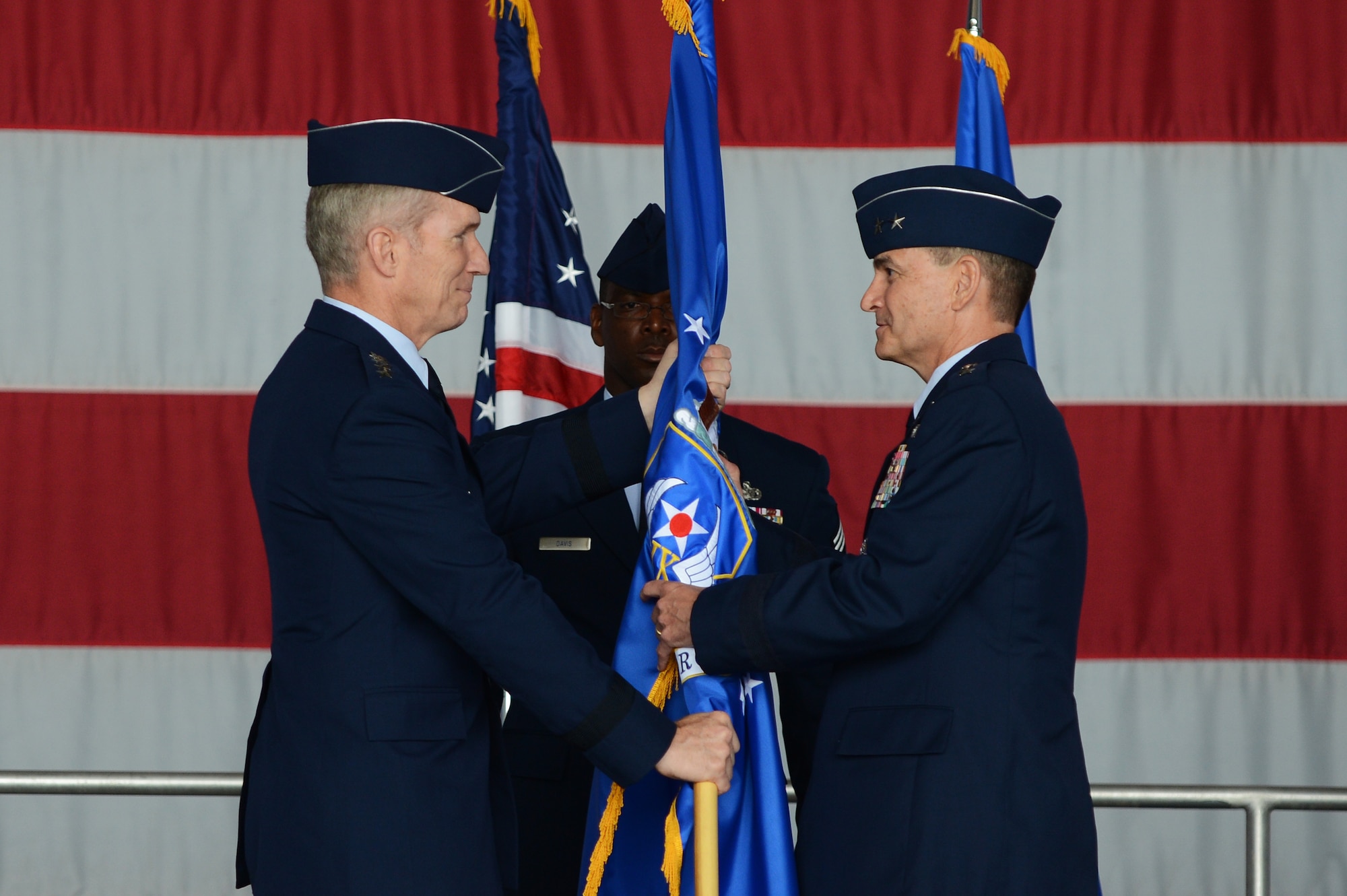 Maj. Gen. Jake Polumbo accepts command of the Ninth Air Force from General Mike Hostage, commander, Air Combat Command, Joint Base Langley-Eustis, during the Ninth Air Force change of command ceremony May 31, 2013, at Shaw Air Force Base, S.C. Polumbo is the fourth commander to take the organization’s helm since its activation, Aug. 5, 2009. (U.S. Air Force photo by Airman 1st Class Daniel Blackwell/Released)