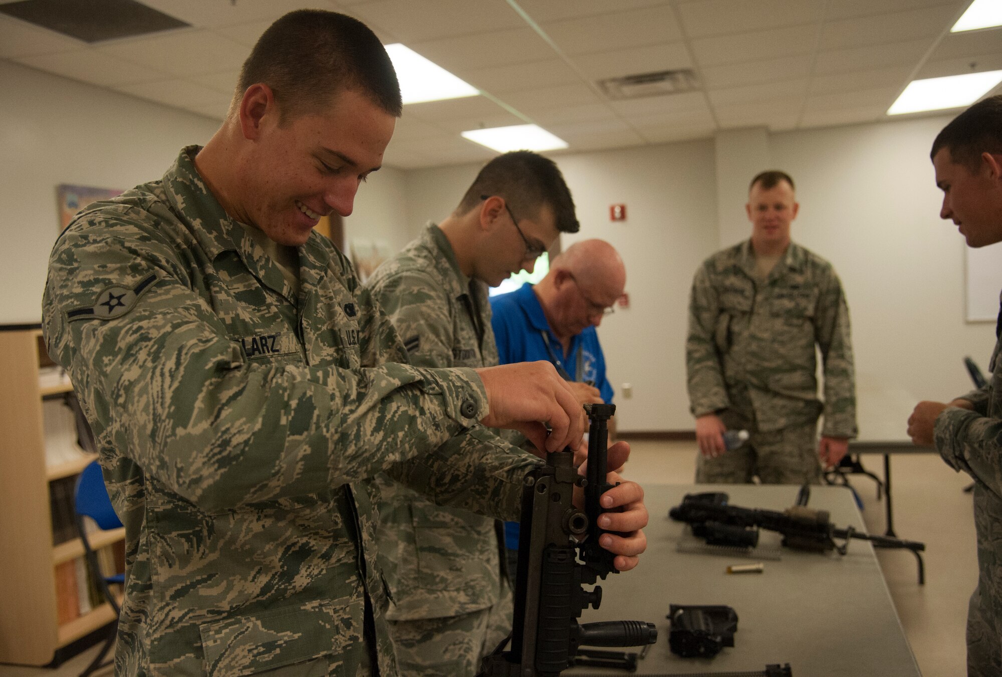 Alan Fox, a former Operation Safeside mortar crewman and a group of 820th Base Defense Group fireteam members piece together a weapons puzzle May 18, 2013. They assembled weapons in a timed completion at Moody Air Force Base, Ga. (U.S. Air Force photo by Airman 1st Class Sandra Marrero/Released)
