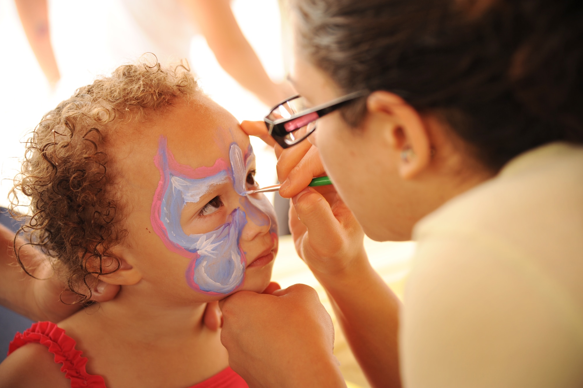 Emma Goodman, daughter of Master Sgt. William Goodman, 45th Aeromedical Evacuation Squadron services member, and Capt. Gavril Goodman, 45th AES flight nurse, sits solemnly while having her face painted at the 927th Air Refueling Wing's Family Day at MacDill Air Force Base, May 4. The annual event for the Air Force Reserve wing allows reservists, their family members and friends to gather together and participate in a variety of morale activities, including such events as raffles, a sporting competition and a car show.  Master Sgt. Goodman spent the day with his daughters and family, but Capt. Goodman could not join the fun as she is currently deployed. Master Sgt. Goodman said the family looks forward to welcoming her home in a few days. (Official U.S. Air Force photo/Staff Sgt. Jennie Chamberlin)