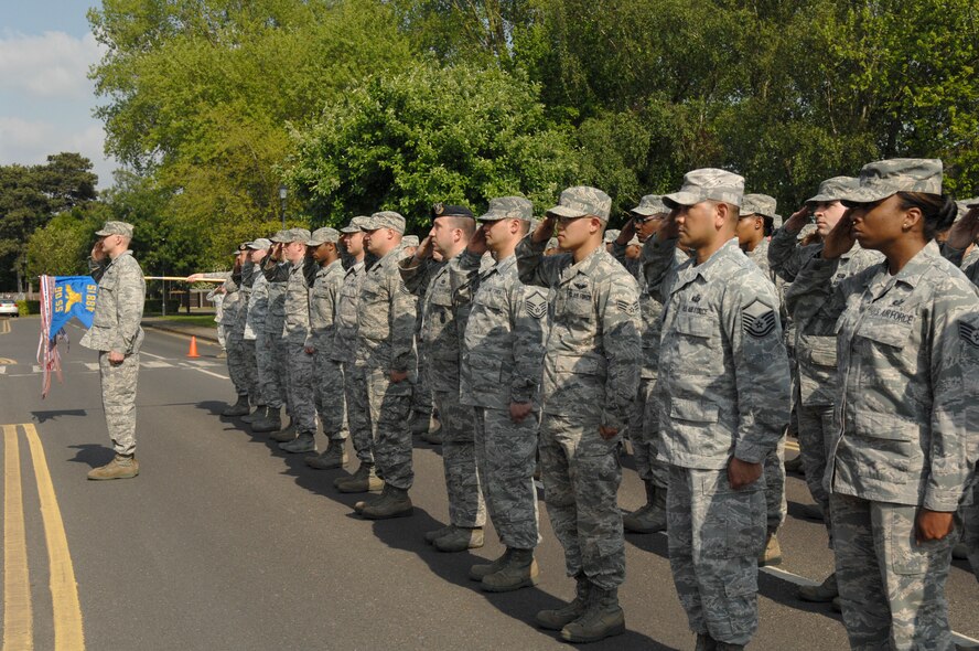 Airmen from the 488th Intelligence Squadron and 95th Reconnaissance Squadron salute the American flag as it is lowered during a monthly retreat ceremony May 31, 2013, outside the 100th Air Refueling Wing Headquarters building on RAF Mildenhall, England. Each month a different unit from RAF Mildenhall pays respect to the American flag and Royal Air Force Ensign by hosting a retreat ceremony. (U.S. Air Force photo by Airman 1st Class Dillon Johnston/Released)