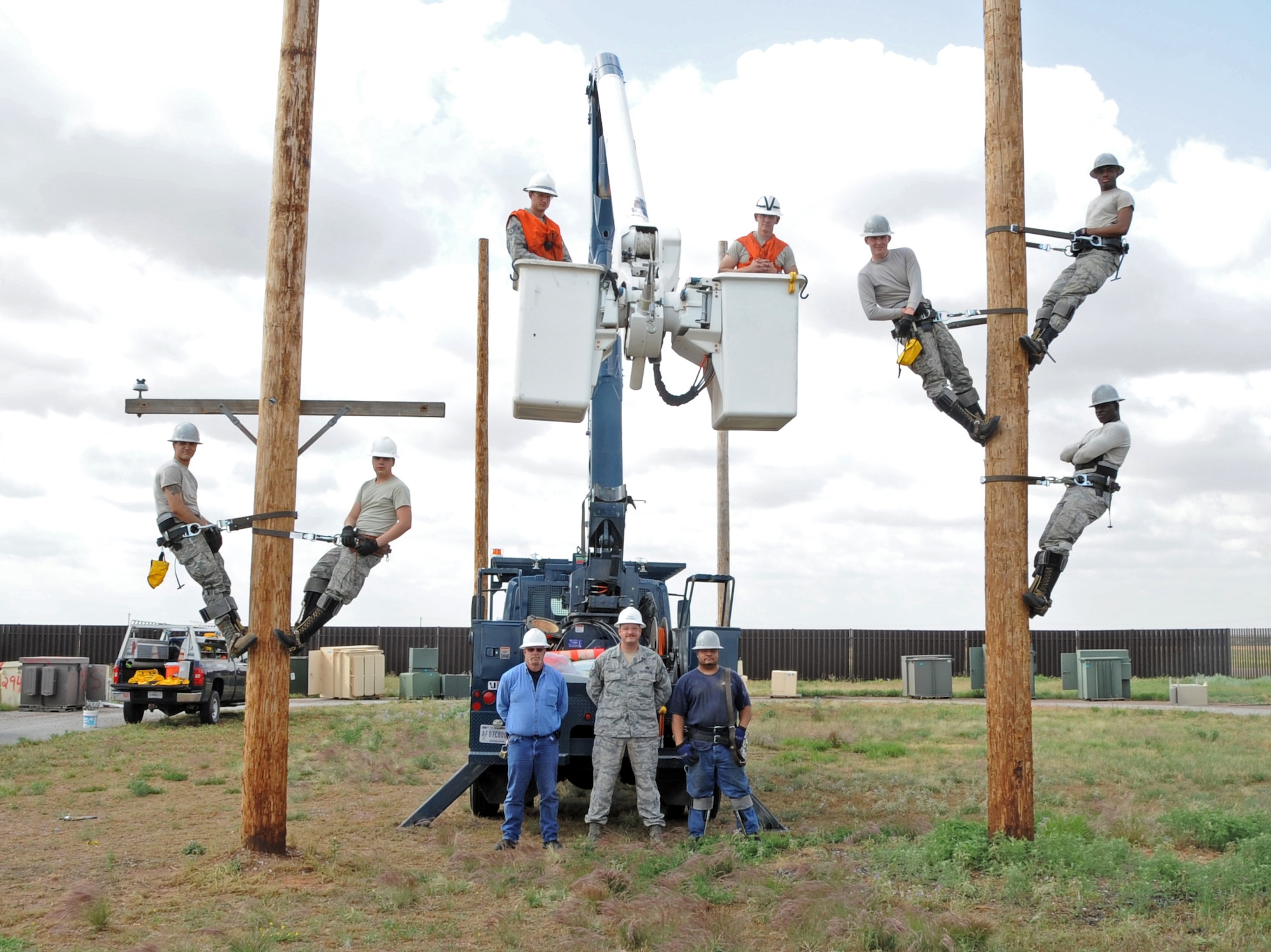 ALTUS AIR FORCE BASE, Okla. – Members of the 97th Civil Engineer Squadron Electric Shop pose for a group photo in the pole yard, May 30. The Electric Shop’s mission is to supply Altus AFB with power. They also maintain energy for the fire alarms, lights on the flightline, low voltage interiors, high voltage exteriors and other sources of energy throughout the base. (U.S. Air Force photo by Airman 1st Class Franklin R. Ramos / Released)