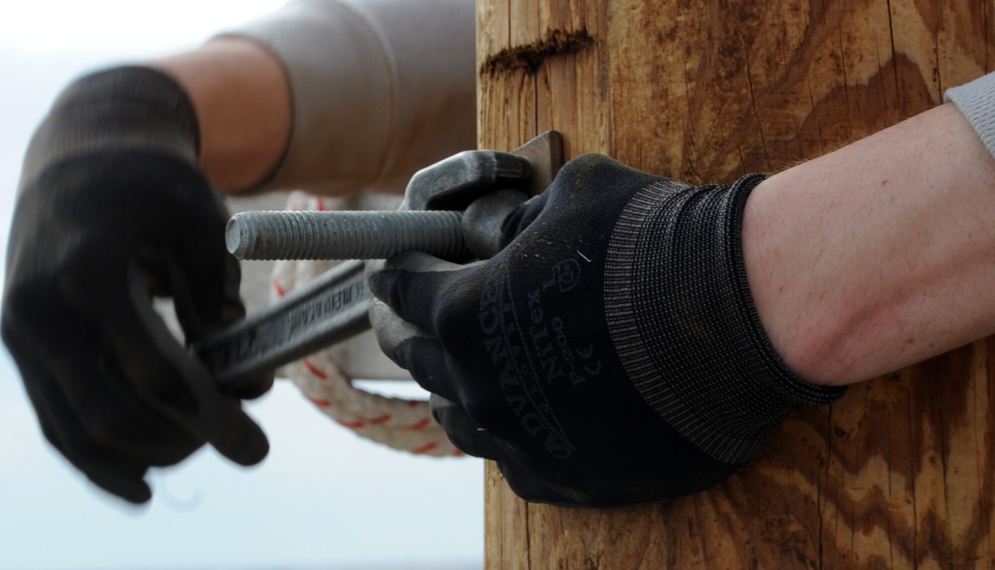 ALTUS AIR FORCE BASE, Okla. – Airman 1st Class Vladimir Purdey, 97th Civil Engineer Squadron electrician, tightens a through-bolt in a utility pole in the pole yard, May 30. The bolt was used to hold a cross arm on a utility pole for power lines and other overhead conductors. The Electric Shop’s mission is to supply Altus AFB with power. They also maintain energy for the fire alarms, lights on the flightline, low voltage interiors, high voltage exteriors and other sources of energy throughout the base. (U.S. Air Force photo by Airman 1st Class Franklin R. Ramos / Released)
