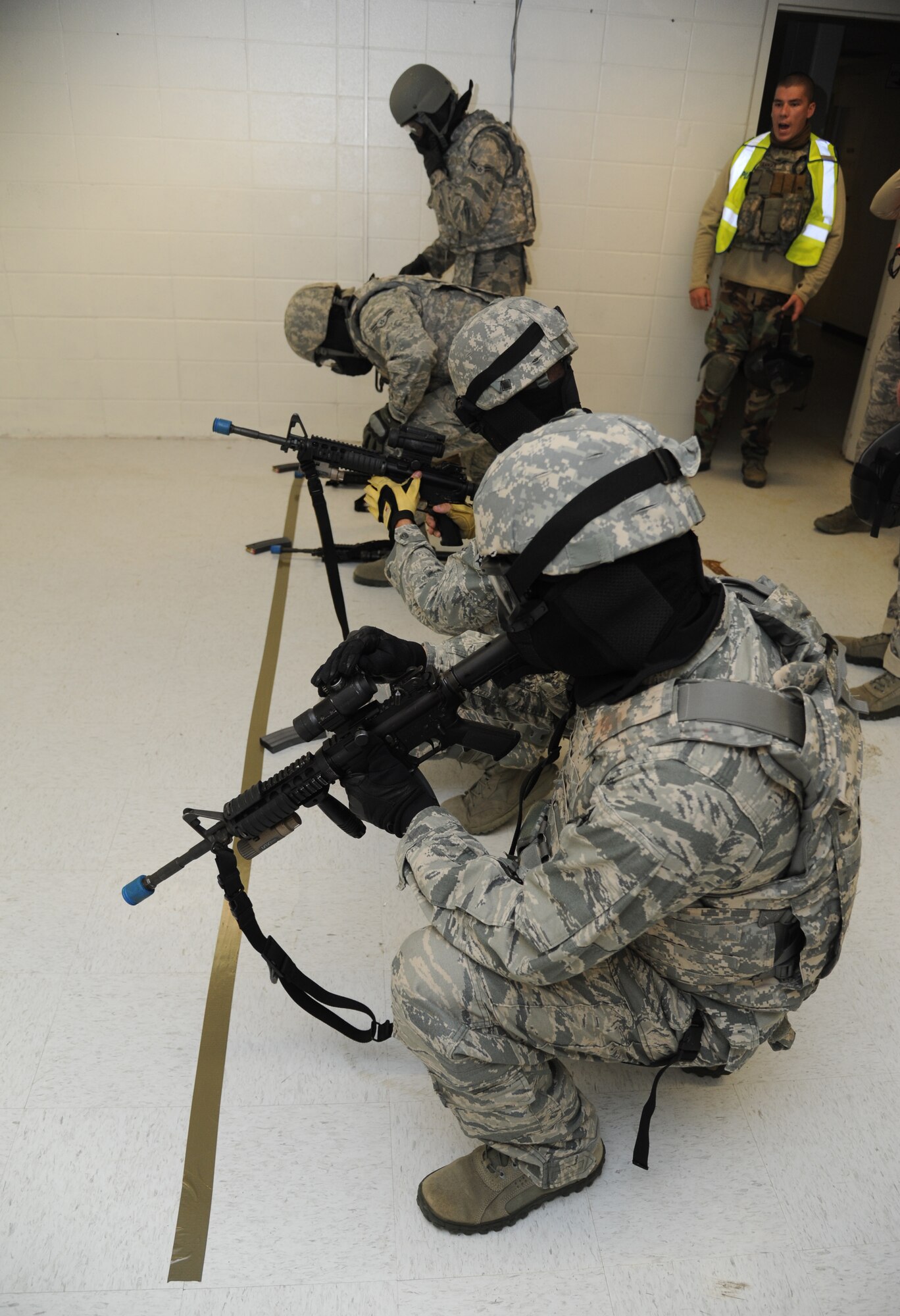 Members of the 81st Security Forces Squadron load their weapons with ammunition prior to walking through active shooter scenarios during training May 28, 2013, at The Locker House, Keesler Air Force Base, Miss.  The two-day annual training helps to prepare them to react during real-world situations.  (U.S. Air Force photo by Kemberly Groue)