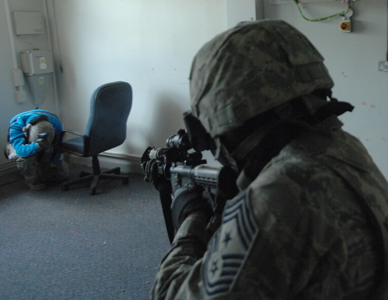 Chief Master Sgt. Tracy Jones, 100th Air Refueling Wing command chief, engages a “hostile” May 31, 2013, during active shooter training at RAF Mildenhall, England. Jones trained with the 100th Security Forces Squadron as part of the “dirty jobs” program. (U.S. Air Force photo by Airman 1st Class Dillon Johnston/Released)