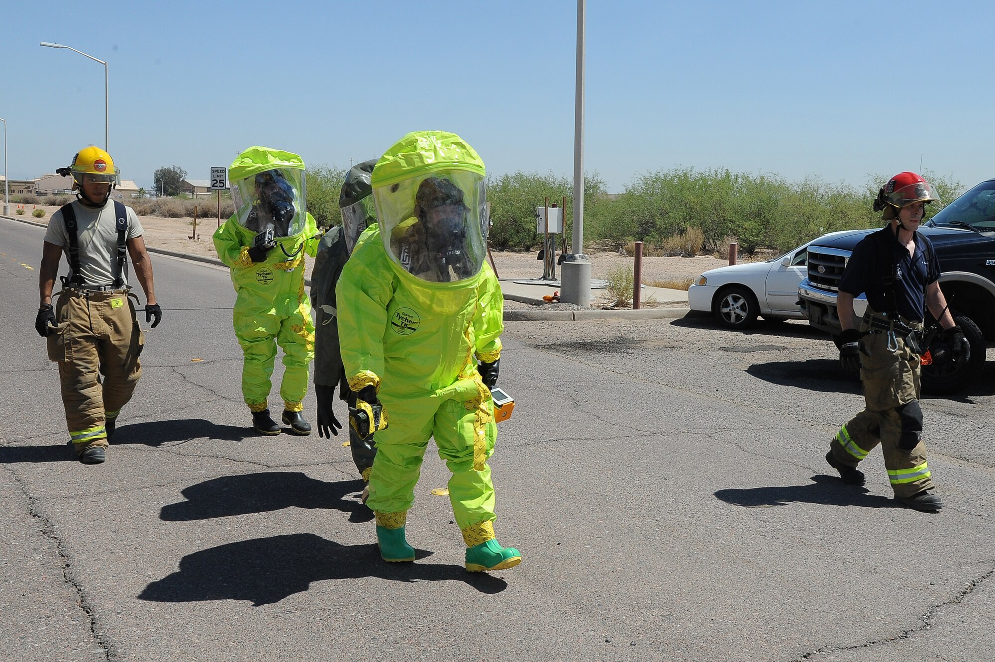 Firefighters from the 56th Civil Engineering Squadron escort biological environmental engineers May 22 from the 944th Fighter Wing and 56th Aerospace Medicine Squadron to a simulated site to scan for hazardous materials. The chemical, biological, radiological, nuclear and explosive exercise was to prepare Luke members for real-world events. (U.S. Air Force photo/Airman 1st Class James Hensley)