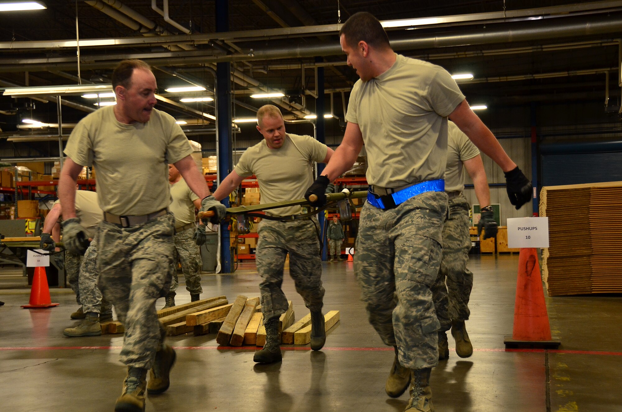 WRIGHT-PATTERSON AIR FORCE BASE, Ohio - Two teams raced against the clock to complete the 87th Aerial Port Squadron team building challenge that included executing 10 push-ups followed by carrying an egg on a stretcher without dropping it before crossing the finish line. The challenge was part of the 445th Airlift Wing annual Wingman Day held during the April 21 unit training assembly. (U.S. Air Force photo/Staff Sgt. Amanda Duncan)
