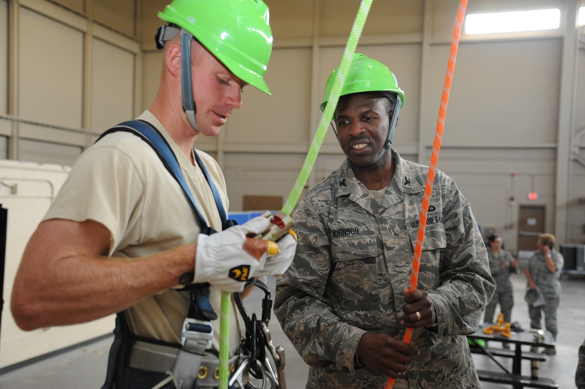 Staff Sgt. Kent Parsons, 338th Training Squadron, demonstrates rope safety techniques used to climb a tower in the airfield system course at Matero Hall to Col. Malcolm “TJ” Johnson, 2nd Air Force vice commander, during Johnson’s two-day immersion with the 81st Training Wing May 29, 2013, at Keesler Air Force Base, Miss.  (U.S. Air Force photo by Kemberly Groue)