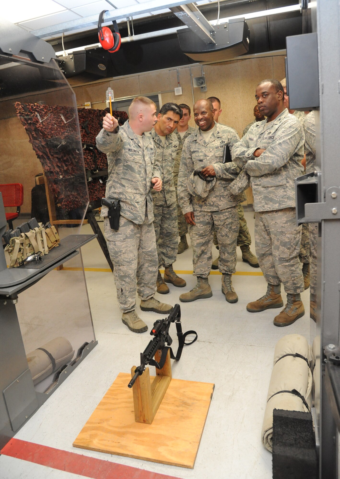 Staff Sgt. Garrett Bullington, 81st Security Forces Squadron, gives a briefing on the targets used at the 81st SFS indoor firing range to Col. René Romero, 81st Training Wing vice commander; Col. Malcolm “TJ” Johnson, 2nd Air Force vice commander, and Col. Mark Vivians, 81st Mission Support Group commander, during Johnson’s two-day immersion with the 81st Training Wing May 28, 2013, at Keesler Air Force Base, Miss.  (U.S. Air Force photo by Kemberly Groue)