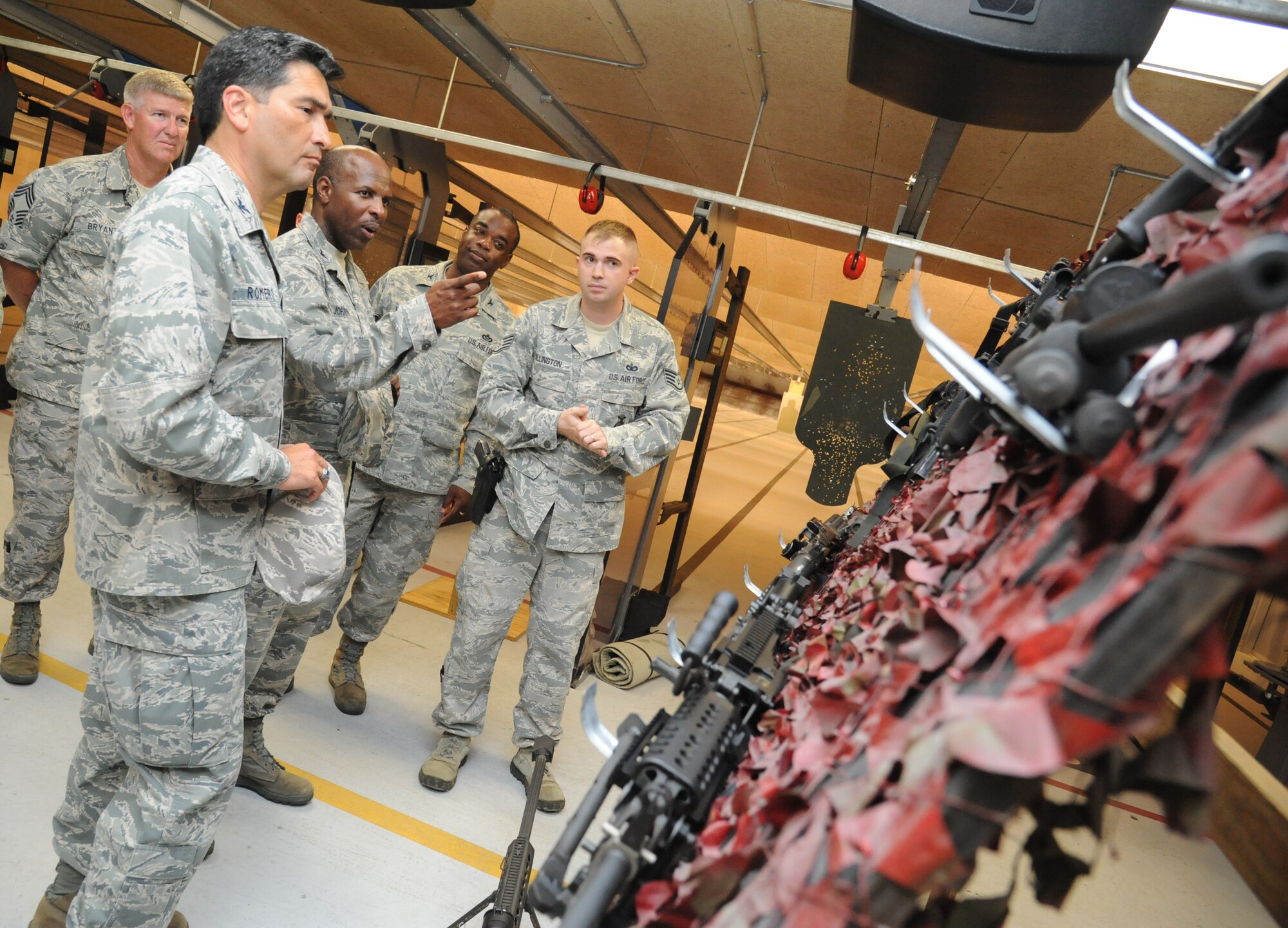 Col. Mark Vivians, 81st Mission Support Group commander, listens as Col. Malcolm “TJ” Johnson, 2nd Air Force vice commander, receives a tour of the 81st Security Forces Squadron indoor firing range from Staff Sgt. Garrett Bullington, 81st SFS, during Johnson’s two-day immersion with the 81st Training Wing May 28, 2013, at Keesler Air Force Base, Miss.  (U.S. Air Force photo by Kemberly Groue)