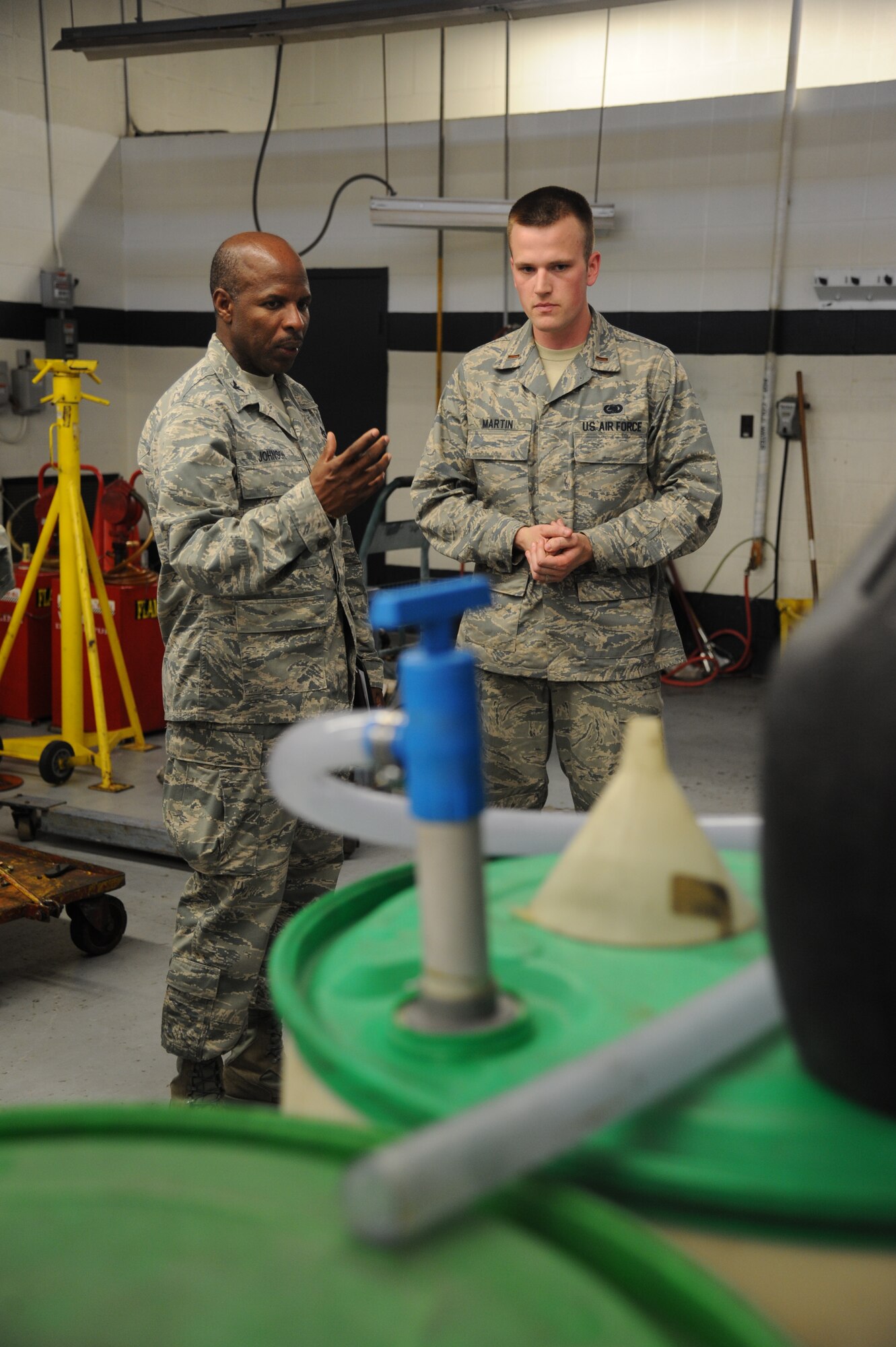 Col. Malcolm “TJ” Johnson, 2nd Air Force vice commander, receives a tour of the vehicle maintenance facility by 2nd Lt. David Martin, 81st Logistics Readiness Squadron vehicle management flight commander, during a two-day immersion with the 81st Training Wing May 28, 2013, at Keesler Air Force Base, Miss.  (U.S. Air Force photo by Kemberly Groue)