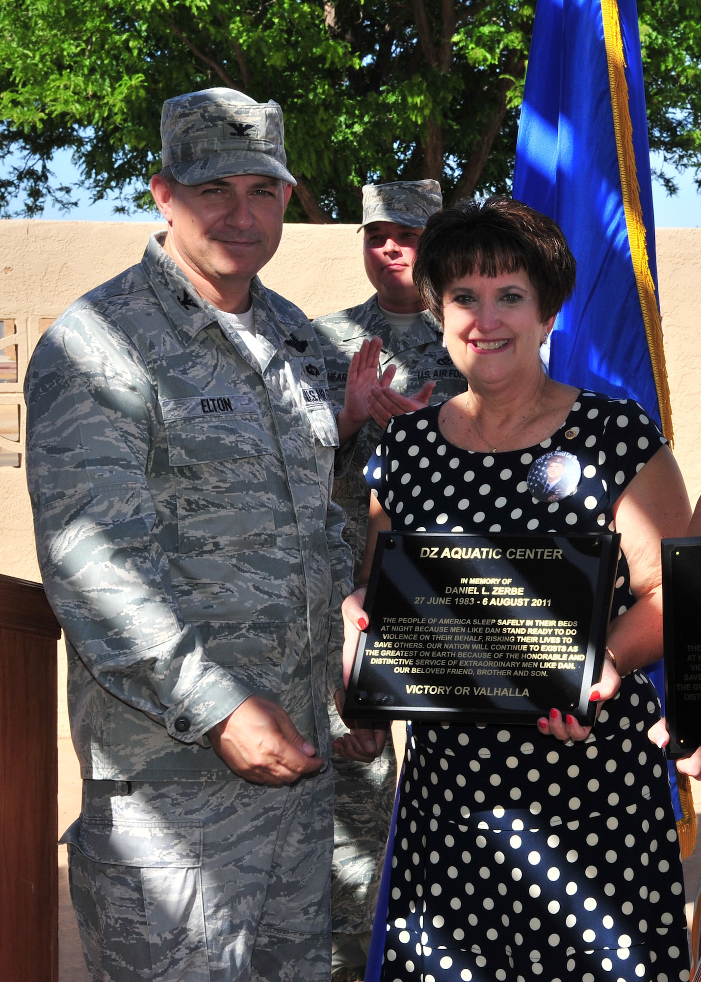 U.S. Air Force Col. Buck Elton, 27th Special Operations Wing commander, presents Susan Zerbe, mother of Tech. Sgt. Daniel L. Zerbe, with a memorization plaque for her son at the base pool at Cannon Air Force Base, N.M., May 27, 2013. The DZ Pool was named in remembrance of Zerbe, a pararescueman who formally served under Air Force Special Operations Command and perished in the line of duty. (U.S. Air Force photo/Senior Airman Alexxis Pons Abascal)