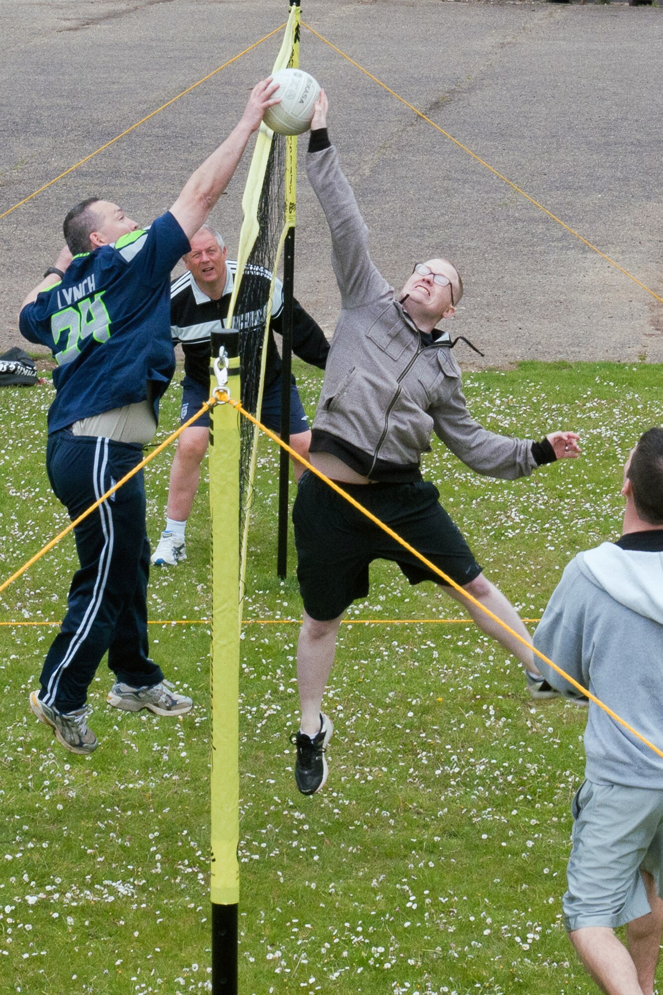 RAF ALCONBURY, United Kingdom – (left to right at net) Senior Master Sgt. Gene Eastman, 501st Combat Support Wing Regional Contracting Office superintendent, and Staff Sgt. Shaun Barton, 501st CSW Finance Office, converge at the net for the ball during the 501st CSW Staff Sports Day at RAF Alconbury May 20. (U.S. Air Force photo by Staff Sgt. Brian Stives)
