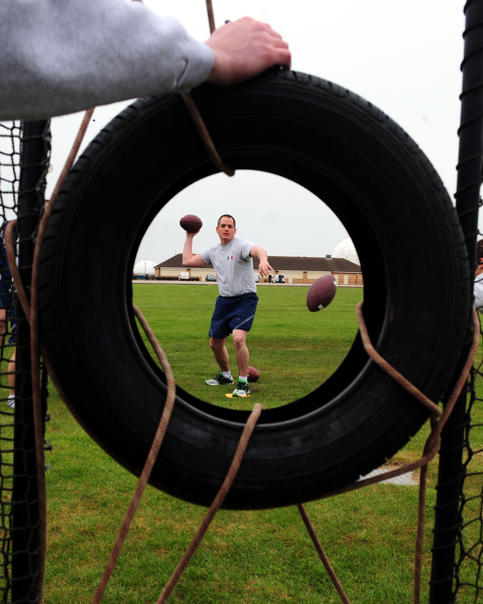 MENWITH HILL, United Kingdom - U.S. Air Force Master Sgt. Bill Rudd, Team Mexico, participates in the football toss during Sports Day May 23, 2013, at Royal Air Force Menwith Hill, United Kingdom. Seventeen three-person "countries" participated in five events, including the welly toss, football toss, free-throw competition, video game archery competition and relay race that consisted of a 1,000-meter row, one-mile run and two-mile bike. (U.S. Air Force photo by Staff Sgt. Debbie Lockhart)
