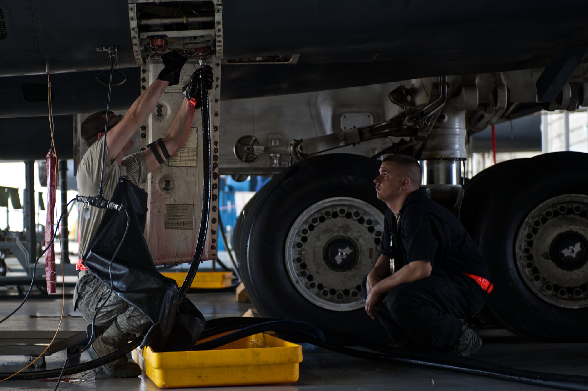 U.S. Air Force Airman 1st Class Christian Erbanski observes Airman 1st Class Cody Frank, both from the 7th Equipment Maintenance Squadron, as he attaches a hydraulic line to a B-1 Bomber during an isochronal inspection May 16, 2013, at Dyess Air Force Base, Texas. During the inspection thousands of items listed in the technical orders are looked over and replaced if necessary.  (U.S. Air Force photo by Tech. Sgt. Joshua T Jasper/Released)