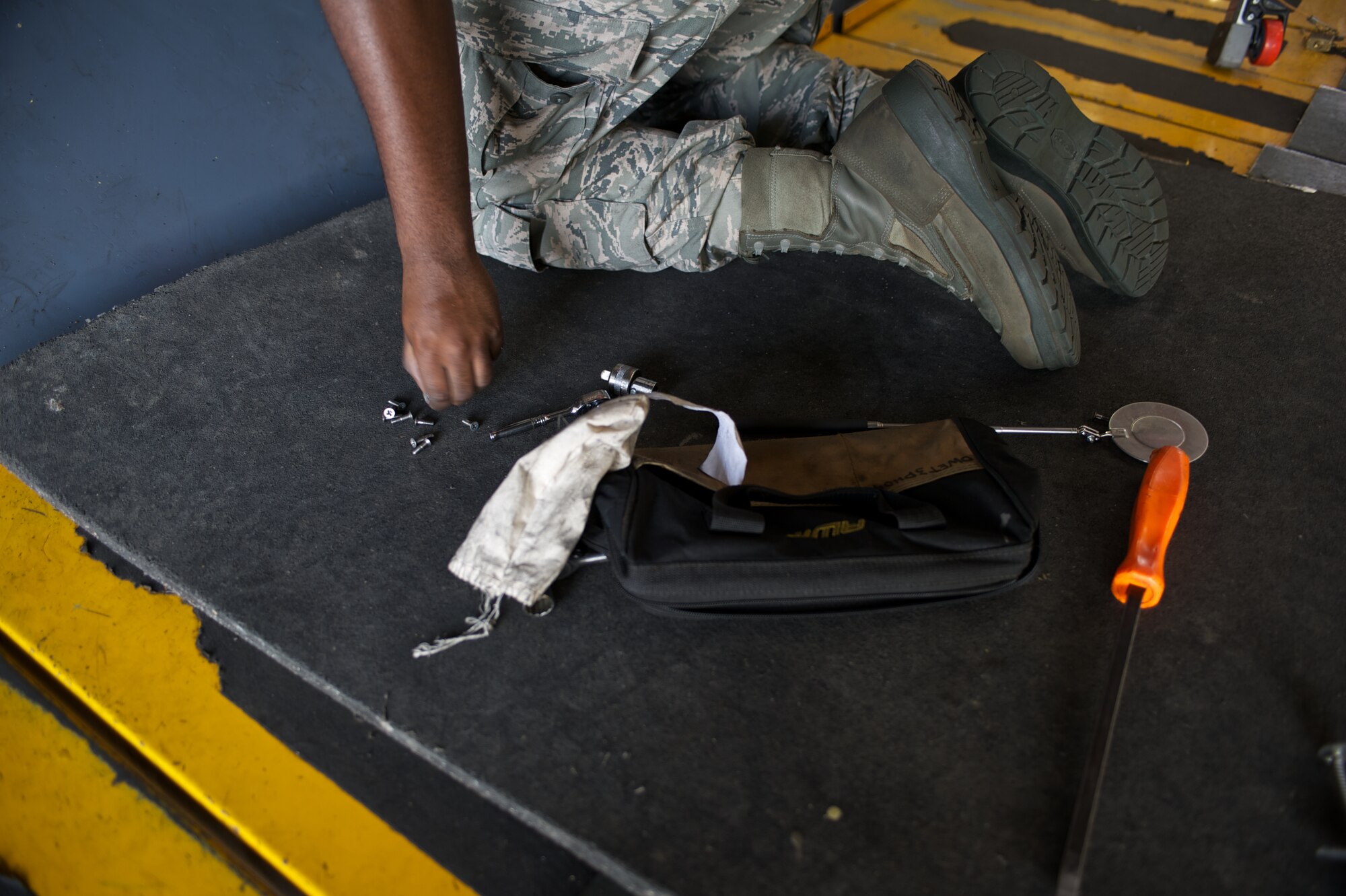 A U.S. Air Force Airman from the 7th Equipment Maintenance Squadron removes screws from a panel on a B-1 Bomber May 16, 2013, at Dyess Air Force Base Texas.   The B-1 Bomber is capable of carrying the largest payload of guided and unguided munitions in the Air Force inventory, and is the backbone of America's long range bomber force. (U.S. Air Force photo by Tech. Sgt. Joshua T Jasper/Released)