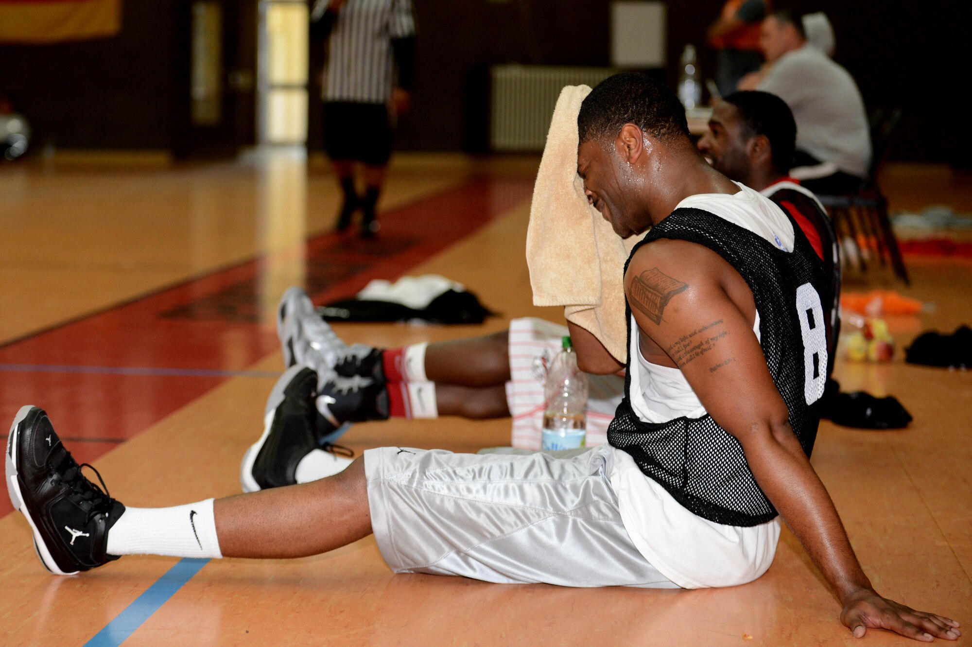 SPANGDAHLEM AIR BASE, Germany -- U.S. Air Force Senior Airman Julius Johnson, 52nd Logistics Readiness Squadron from Lexington Ky., wipes sweat off his face during a wing sports day basketball competition May 30, 2013. Airmen participated in various events representing their squadrons during the 2013 sports day event. (U.S. Air Force photo by Airman 1st Class Kyle Gese/Released)