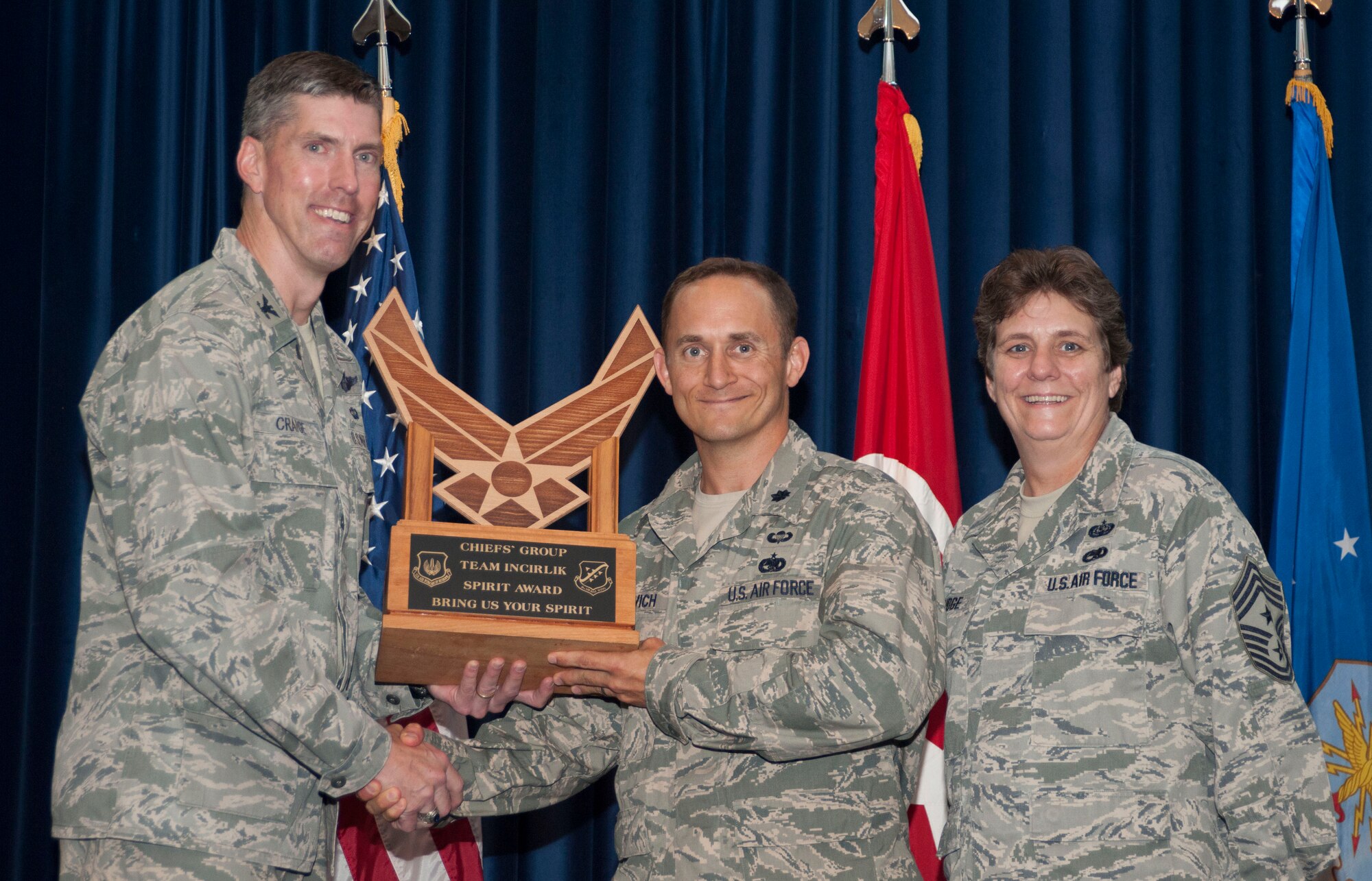 Lt. Col. James Gherdovich, 39th Logistics Readiness Squadron commander, center, accepts the Chief's Spirit Award from Col. Chris Craige, 39th Air Base Wing commander, on behalf of the 39th LRS during the promotion and awards ceremony May 31, 2013, at Incirlik Air Base, Turkey. The award is presented to the squadron that displays the most espirit de corps during the ceremony. (U.S. Air Force photo by Senior Airman Anthony Sanchelli/Released)

