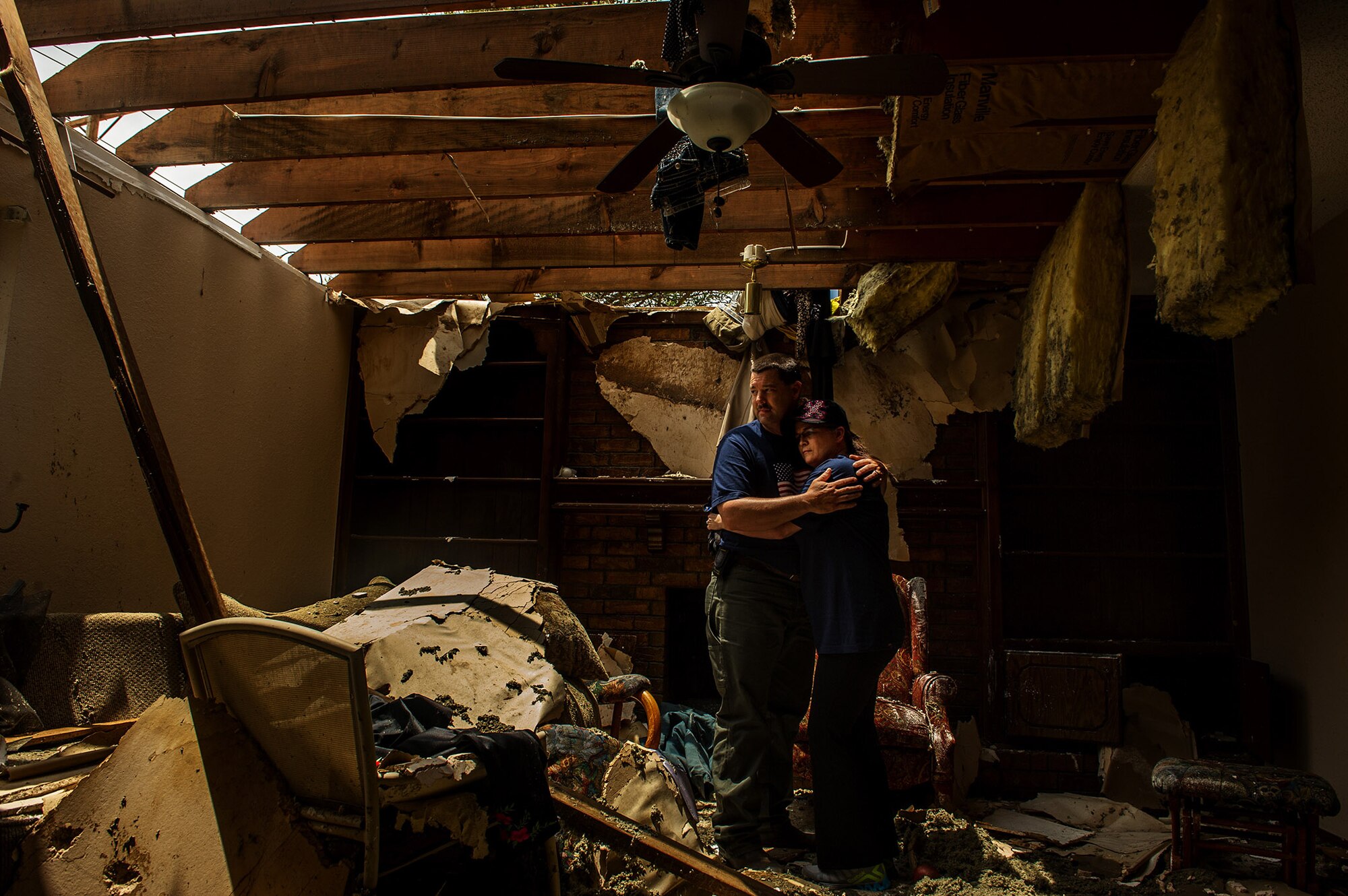 Tech. Sgt. Rhonda Stockstill embraces husband Lendle Stockstill May 27, 2013, in the shattered remnants of their former home that was destroyed by an EF-5 tornado that ripped through their neighborhood of Moore, Okla., May 20, 2013. The Stockstills huddled under the stairs as the storm ravaged their home. Once it passed, the Airman rushed to provide medical aid to students and faculty members who were injured and trapped in nearby Briarwood Elementary School.  Sergeant Stockstill is a surgical technician assigned to the 72nd Medical Group at Tinker Air Force Base, Okla. (U.S. Air Force photo/Staff Sgt. Jonathan Snyder)