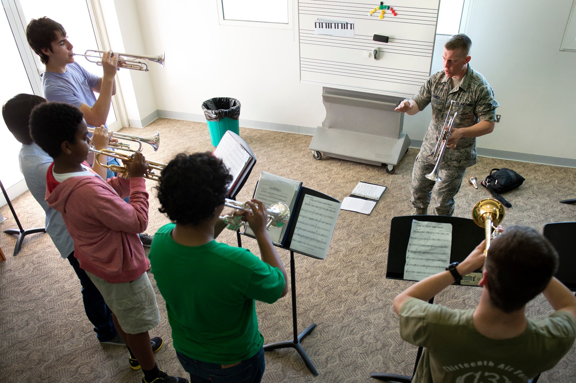 Senior Airman Carl Stanley, AFCENT Band trumpet player, mentors high school band students at the American School of Doha May 30, 2013. Stanley, along with two other brass instrumentalists, conducted a masters class with students in their final weeks of school.  ASD is attended by students from more than 80 nations. (USAF Photo by Master Sgt. Ben Bloker)